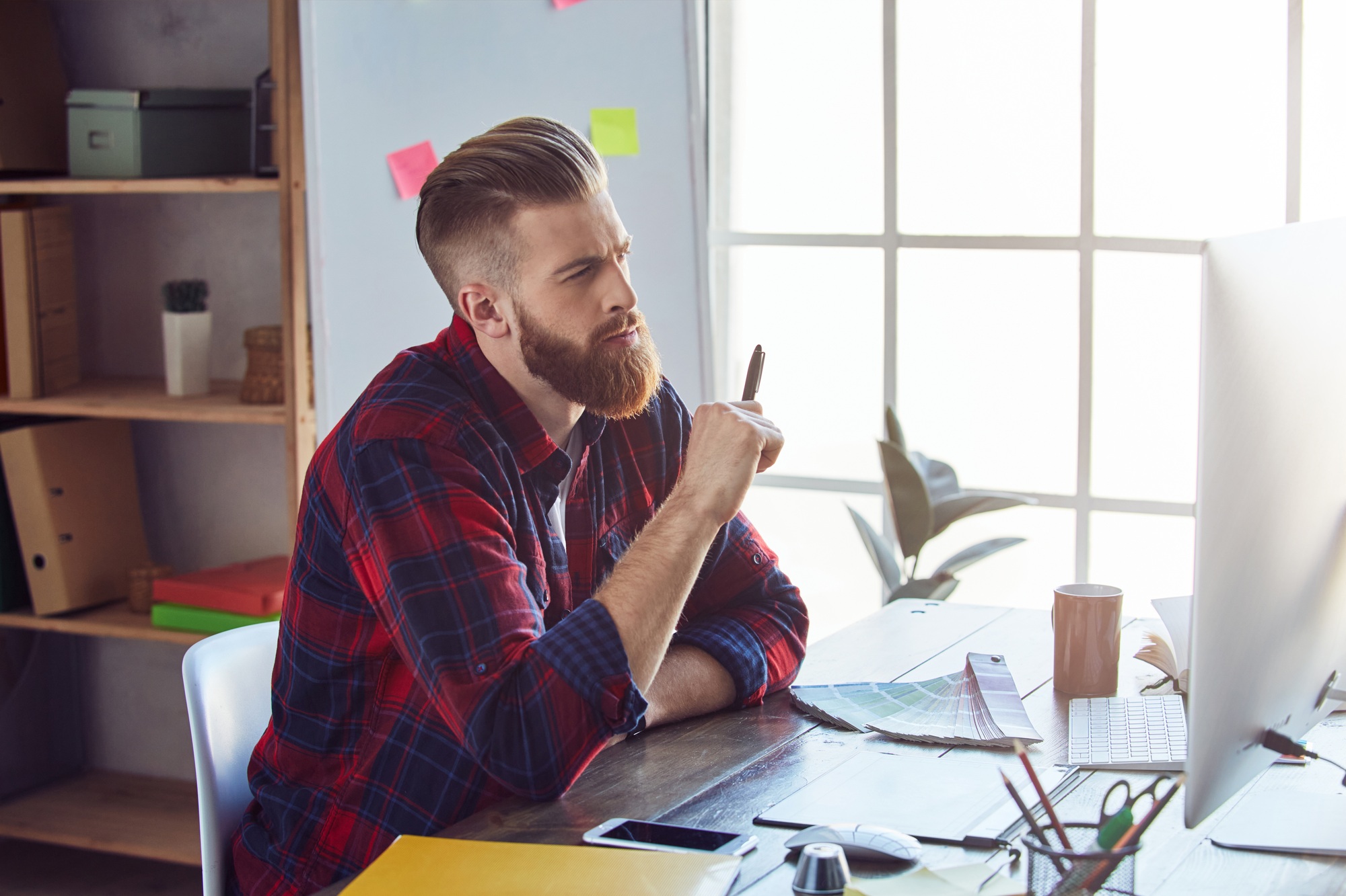 Designer using graphic tablet and working on computer