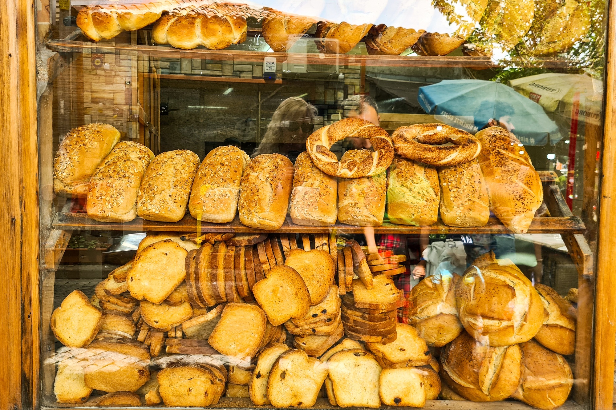 Different tipes of bread displayed at shop window.
