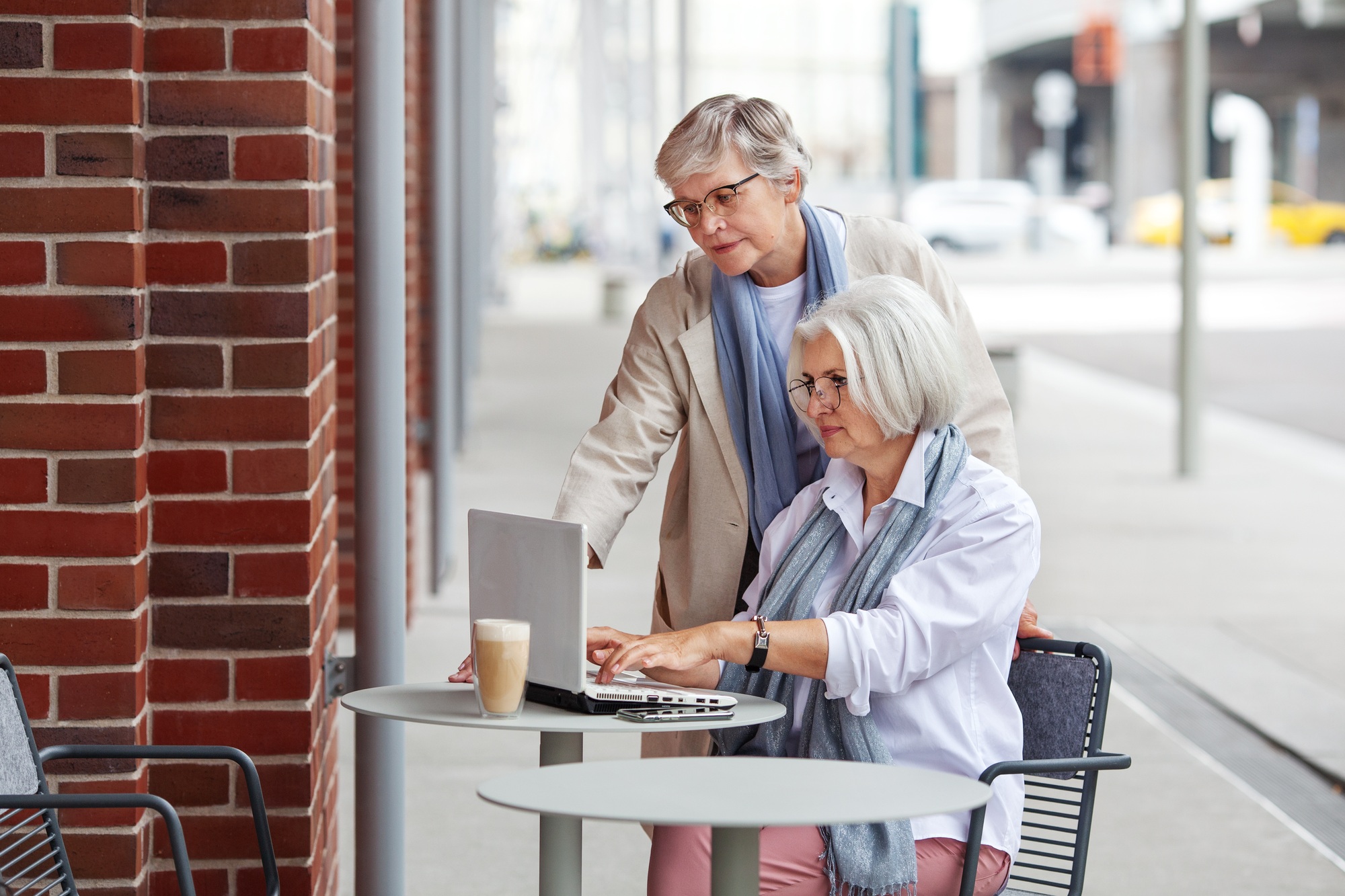 Elderly businesswomen at business meeting in outdoor cafe in the city. Beautiful mature senior women