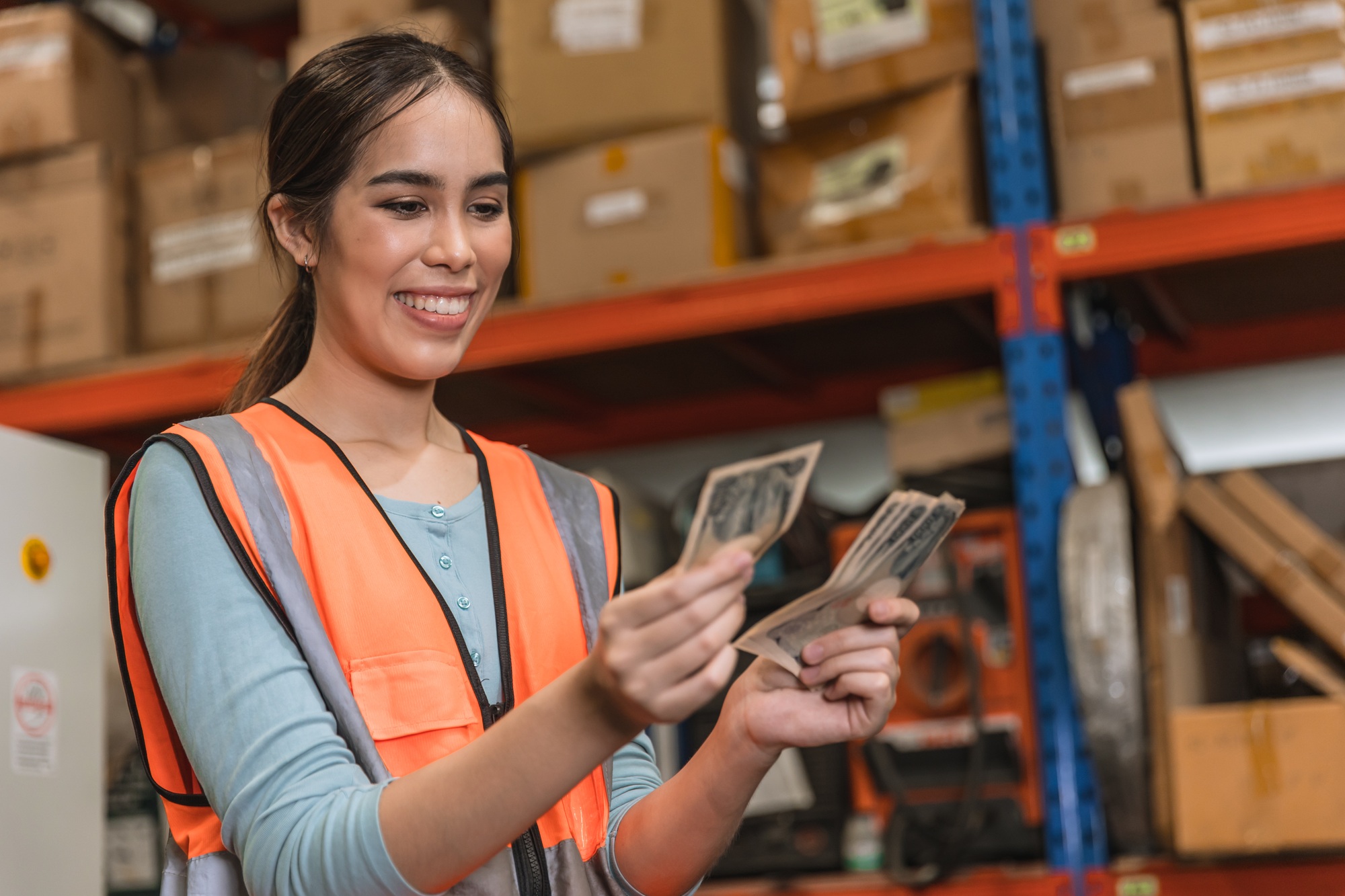 Engineer warehouse staff employee happy glad to recieve salary increase. industry woman worker happy