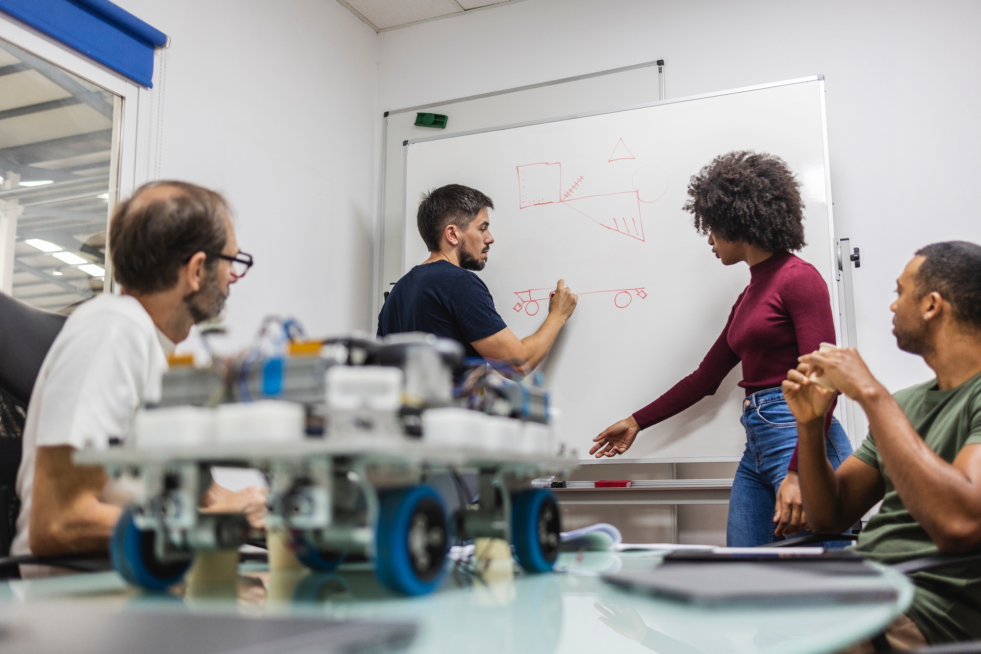 Engineers designing robotics prototype in modern factory