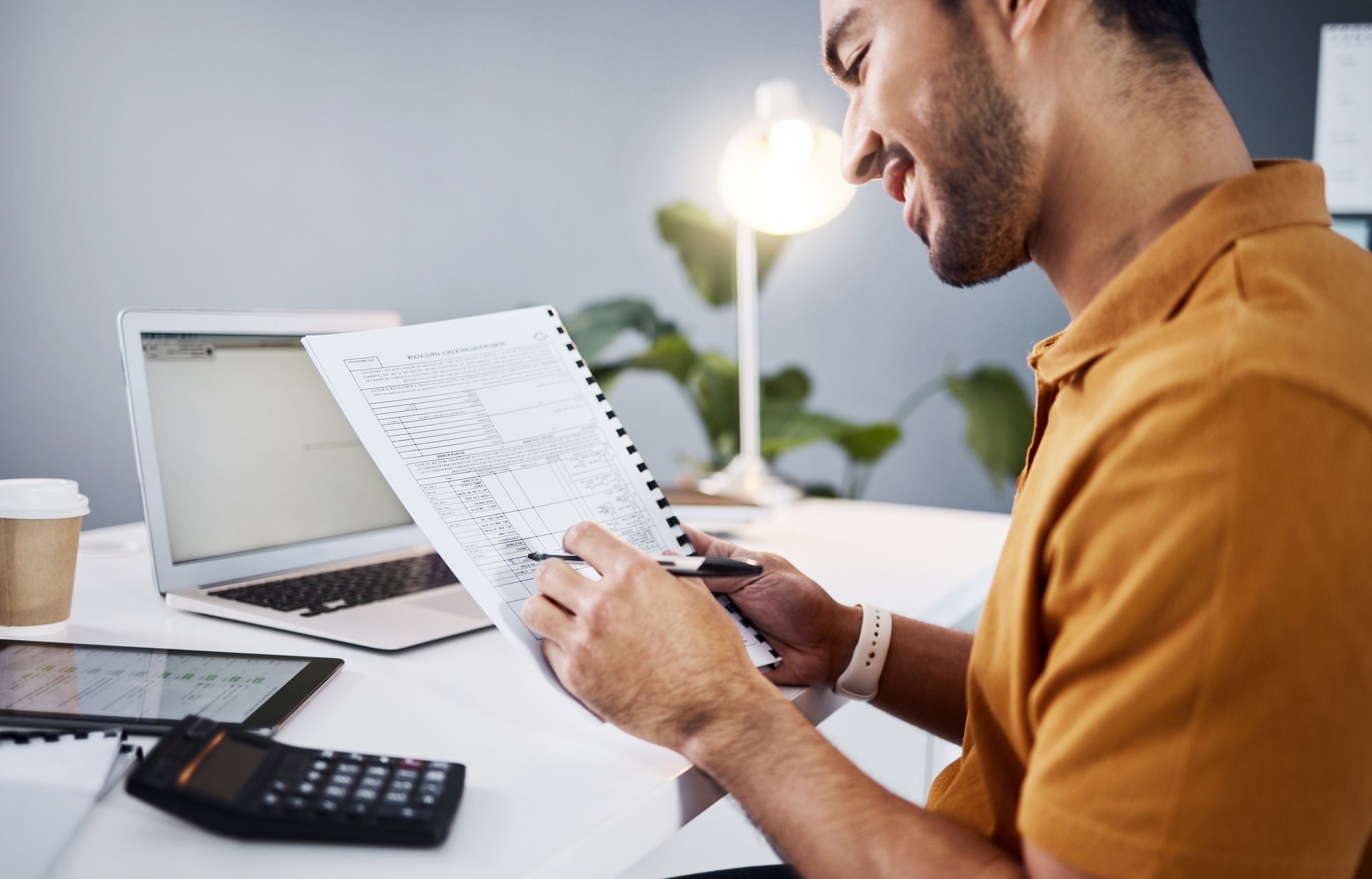 Finance, documents and calculator of business man with taxes, accounting and profit, revenue or gro