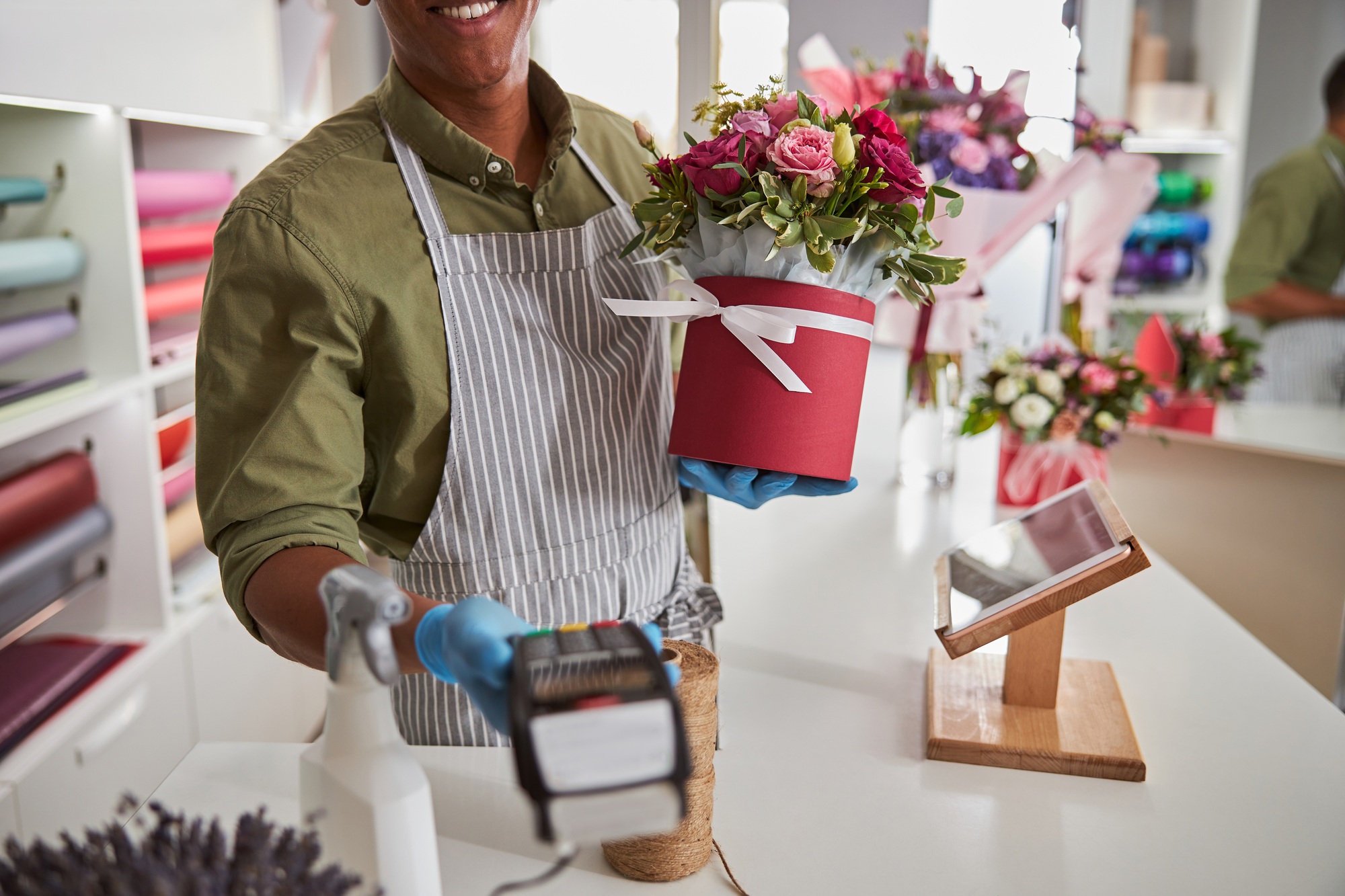 Flower store salesperson offering a card reader