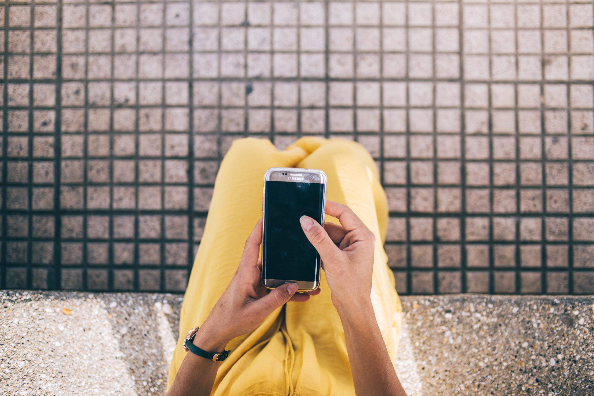Freelancer using smartphone on street in city