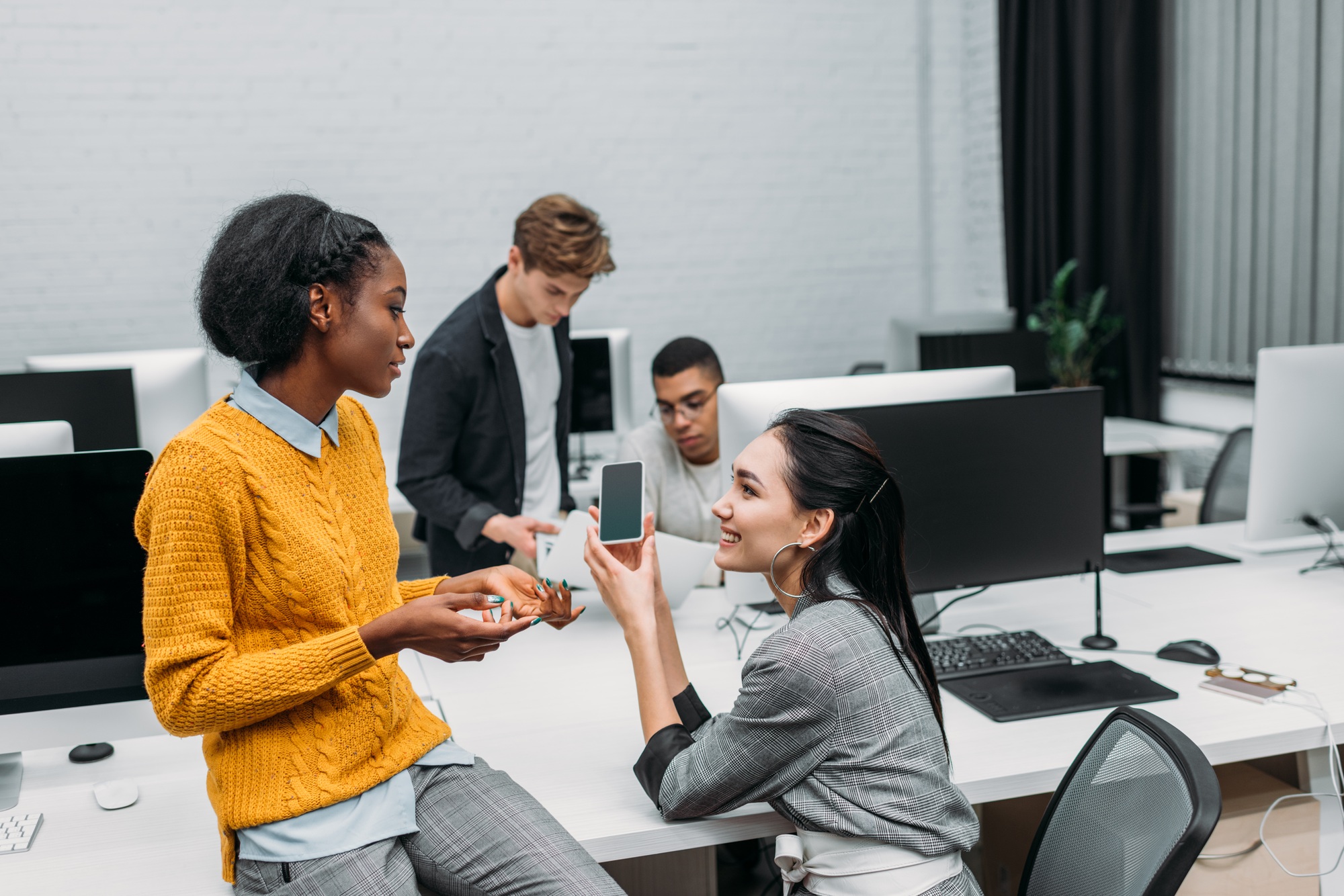 group of multiethnic business partners talking at office