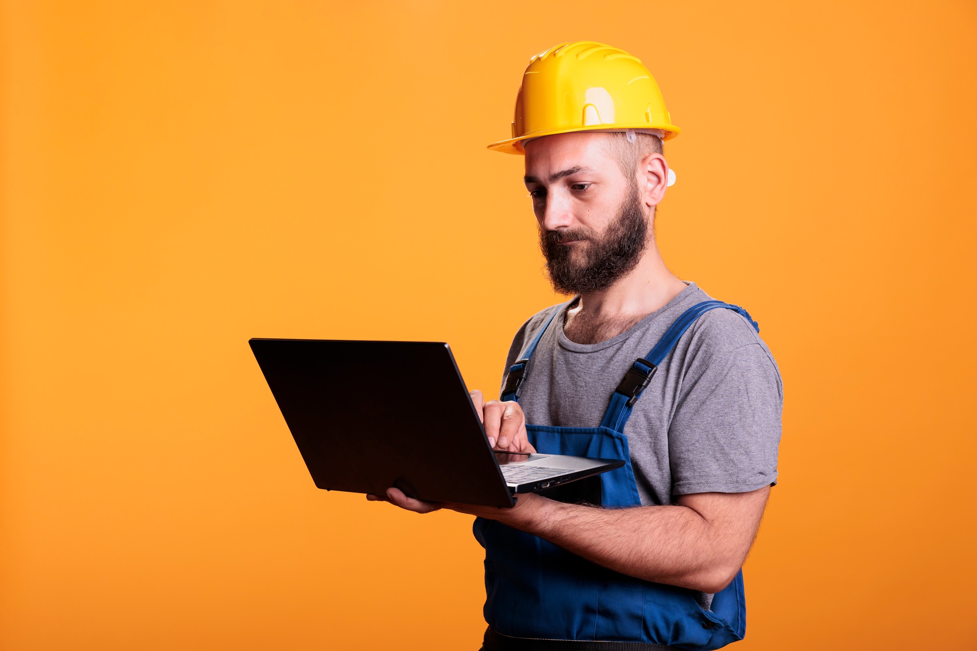 Handyman using laptop to browse internet website
