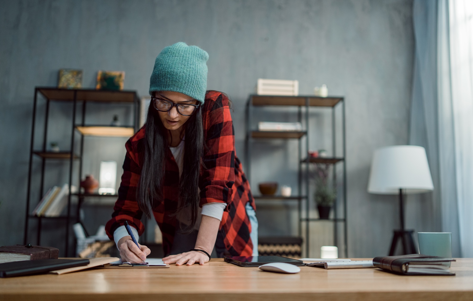 Happy female video editor works indoors in creative office studio