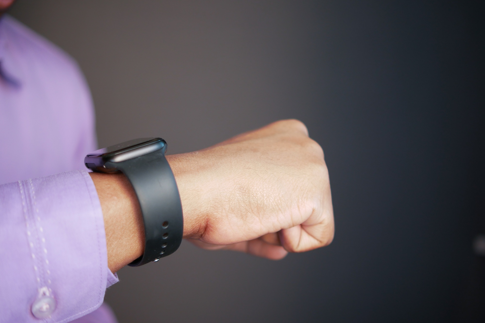 man's hand using smart watch.