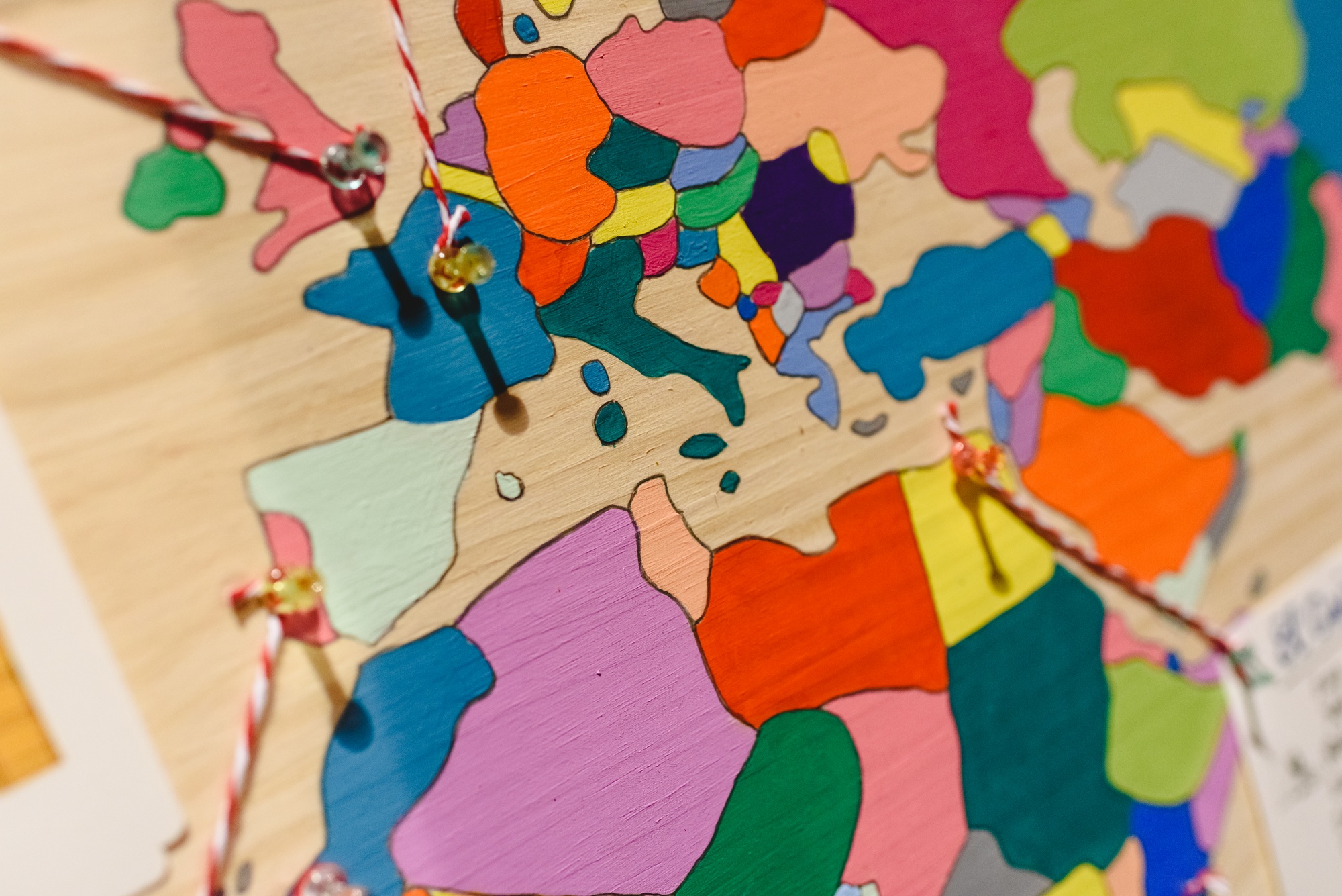 Map of Europe with thumbtacks and threads joining countries.