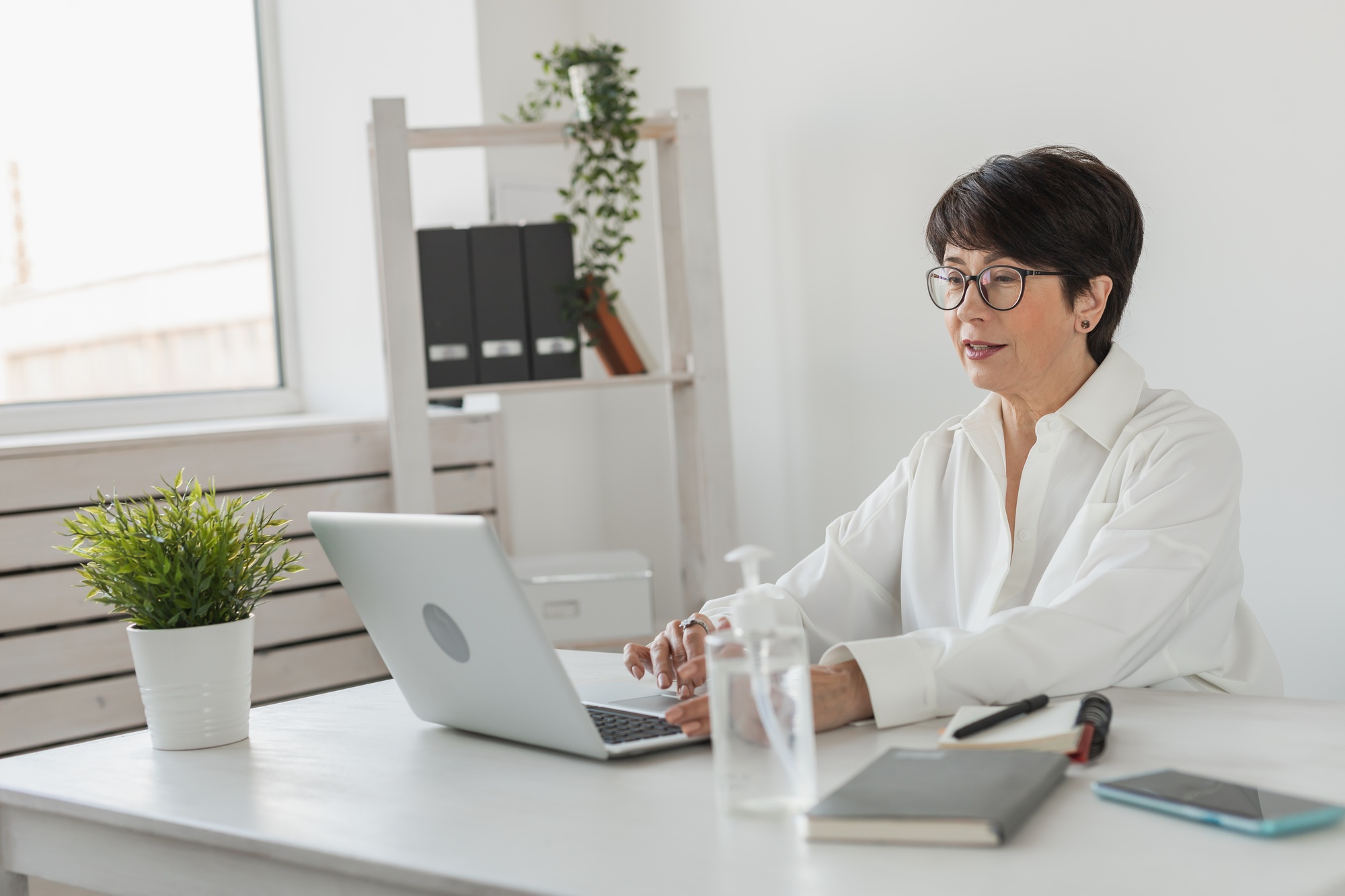 Mature business woman talking about sale report in video conference. Female using laptop online