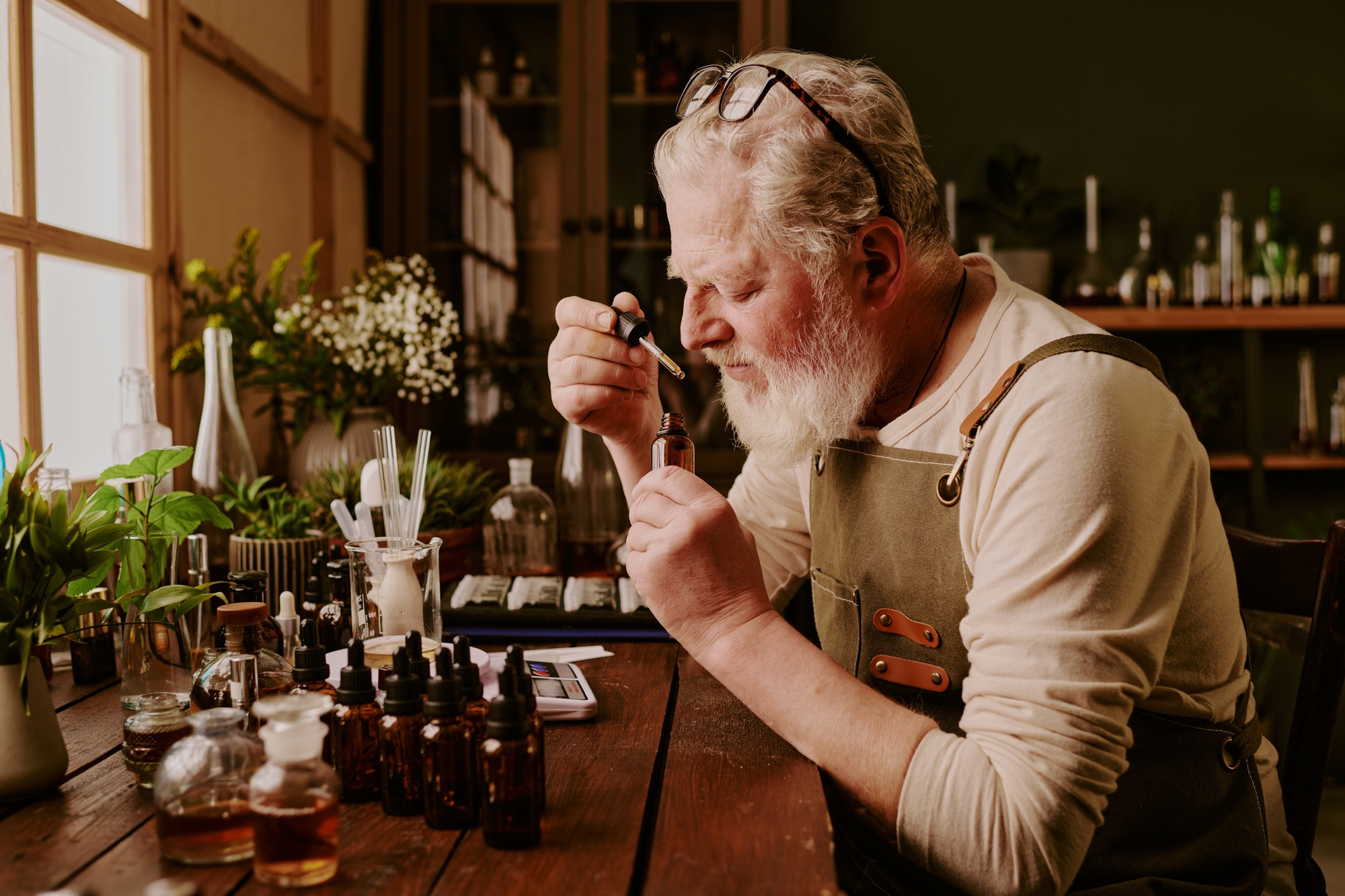 Mature Perfumer Smelling Perfume Scent