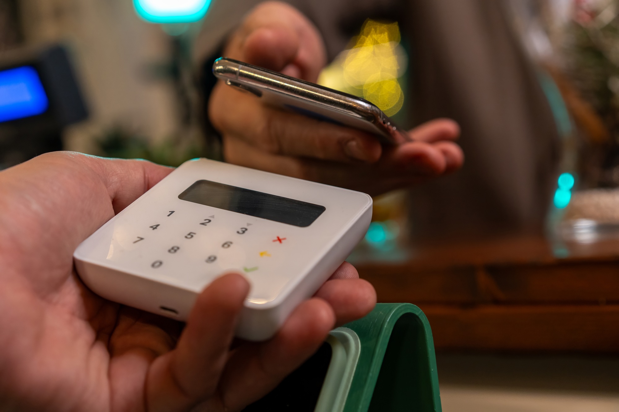 Mobile payment with smartphone and card reader, contactless transaction in cafe
