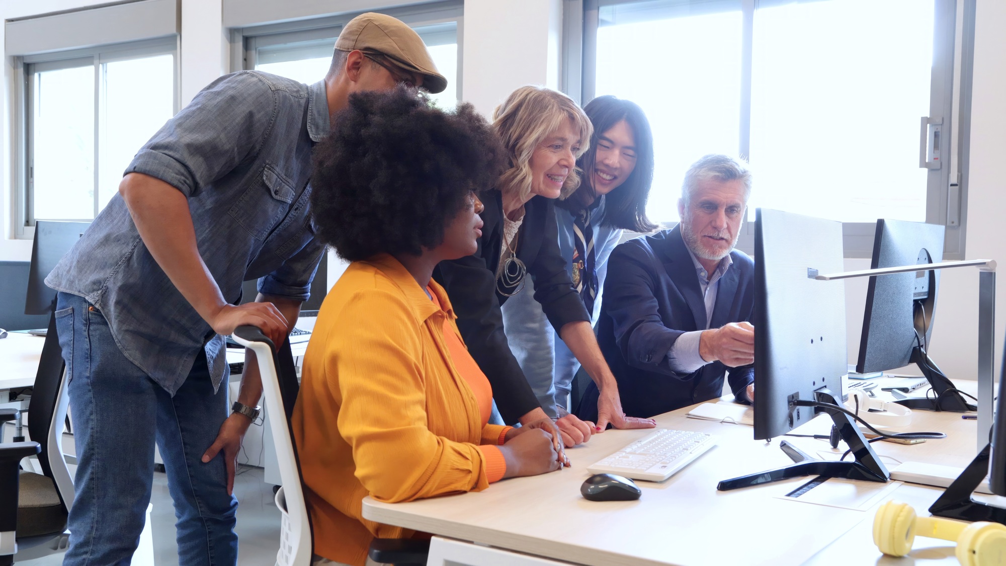 Multicultural work team working together on a project in an office