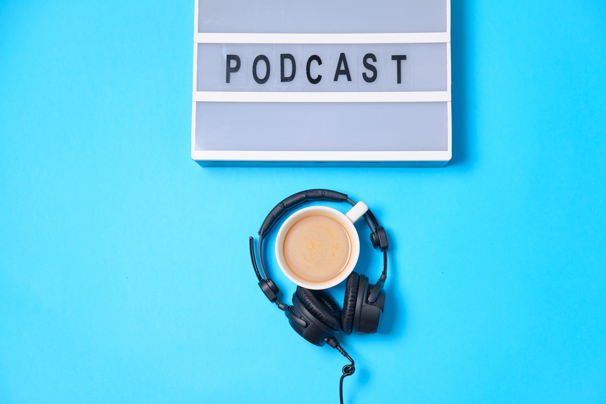 Music  background with Podcast word on lightbox,  headphones