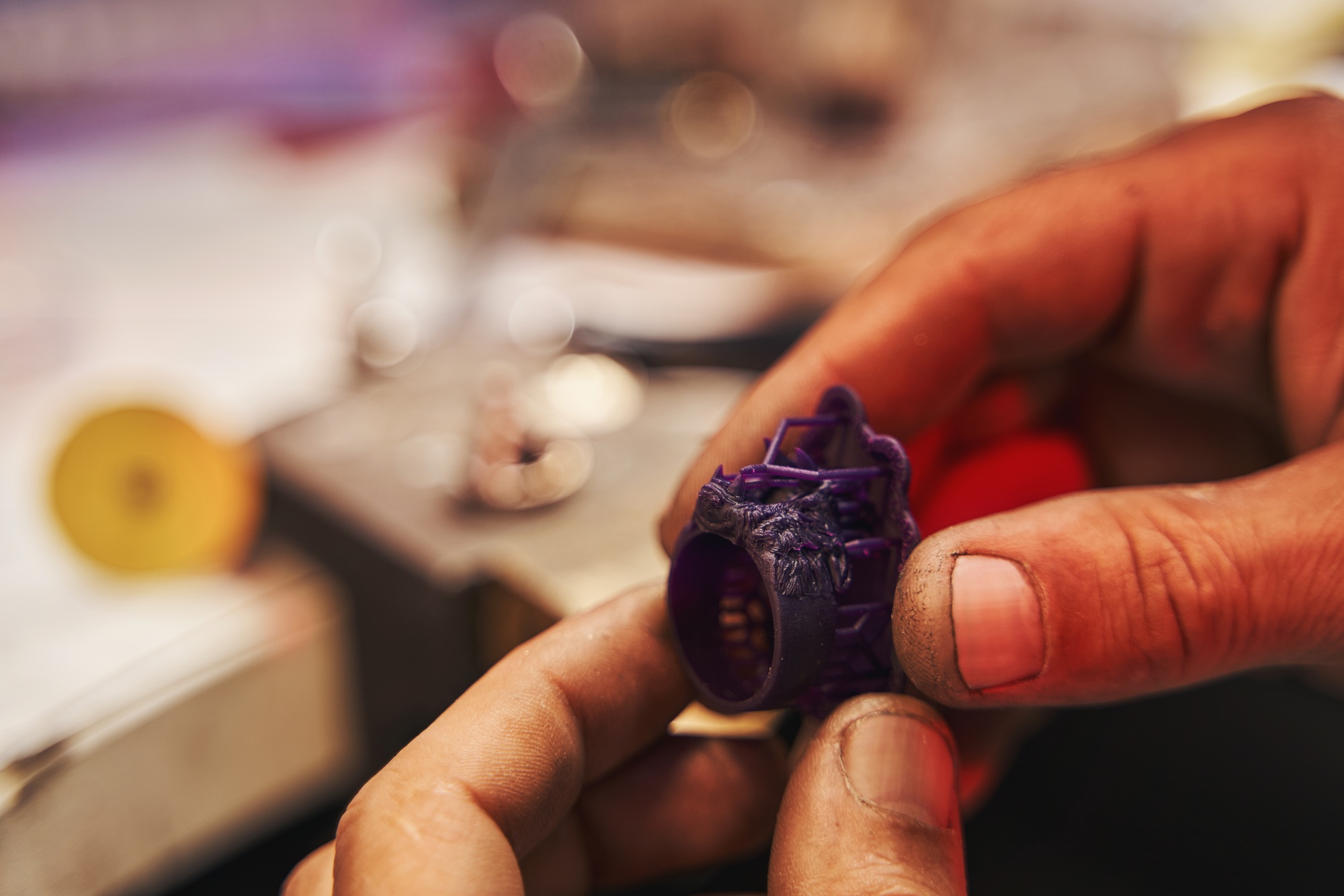Plastic ring prototype in hands of jeweler