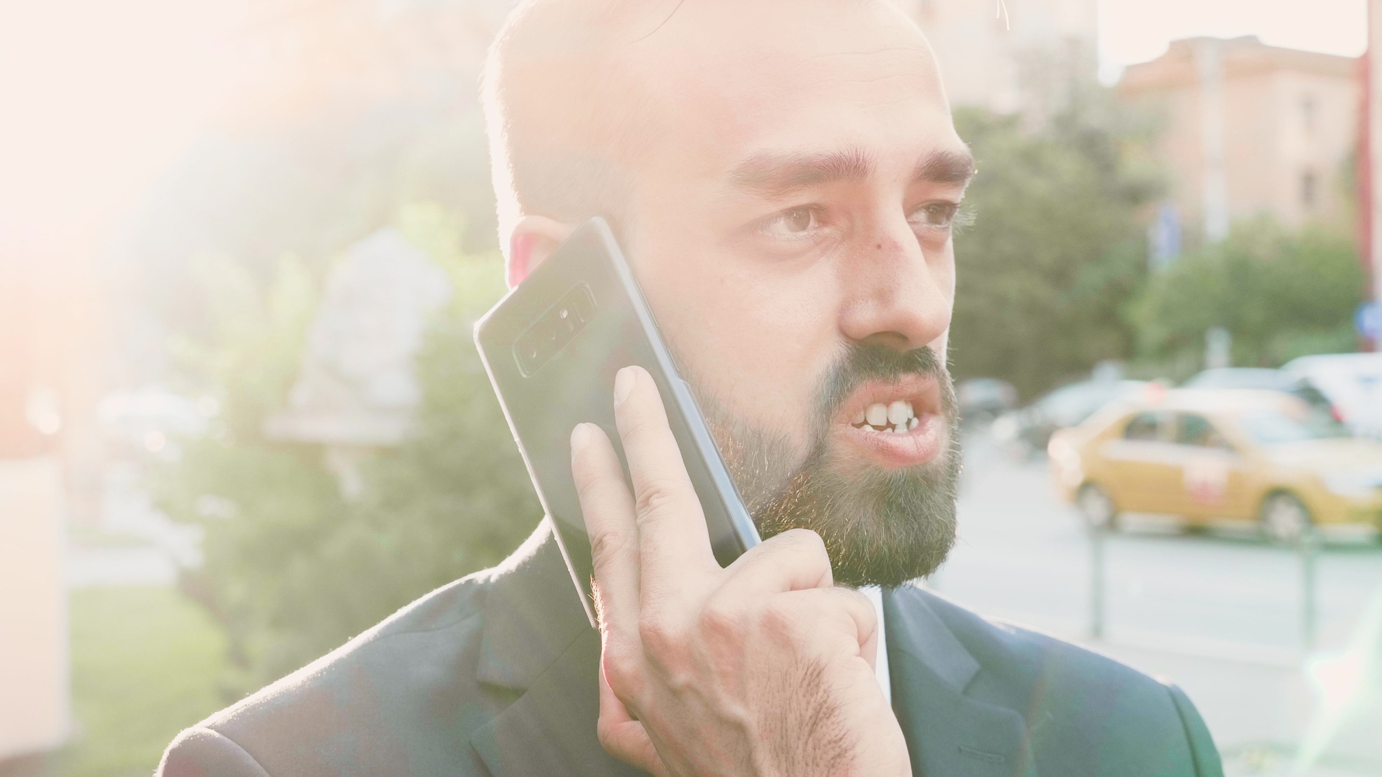 Portrait of entrepreneur man in suit talking at phone discussing management project