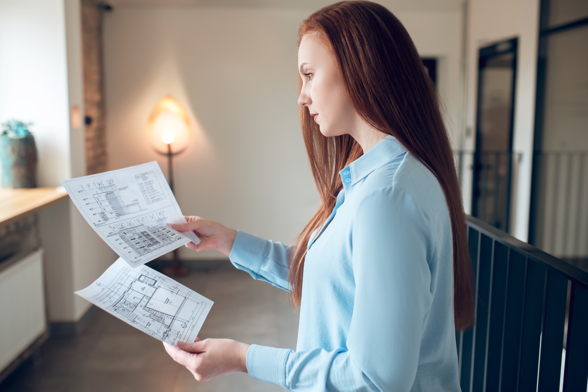 Profile of thinking woman with construction plan