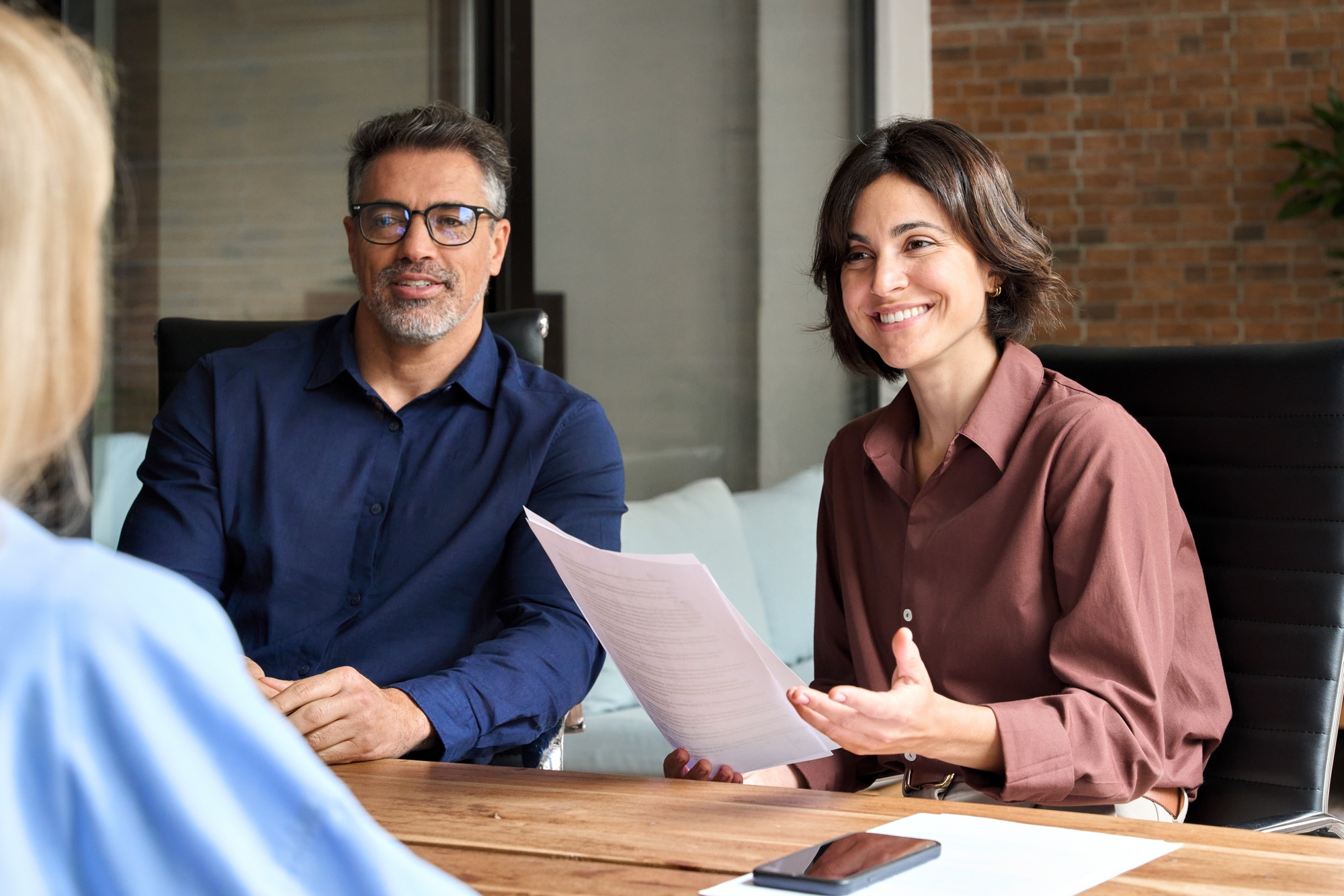Recruitment hr manager interviewing young woman at corporate group meeting.