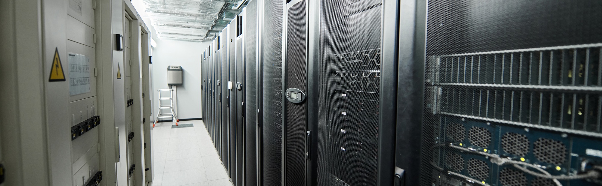 Rows of server racks highlight advanced computer systems supporting cloud services, banner