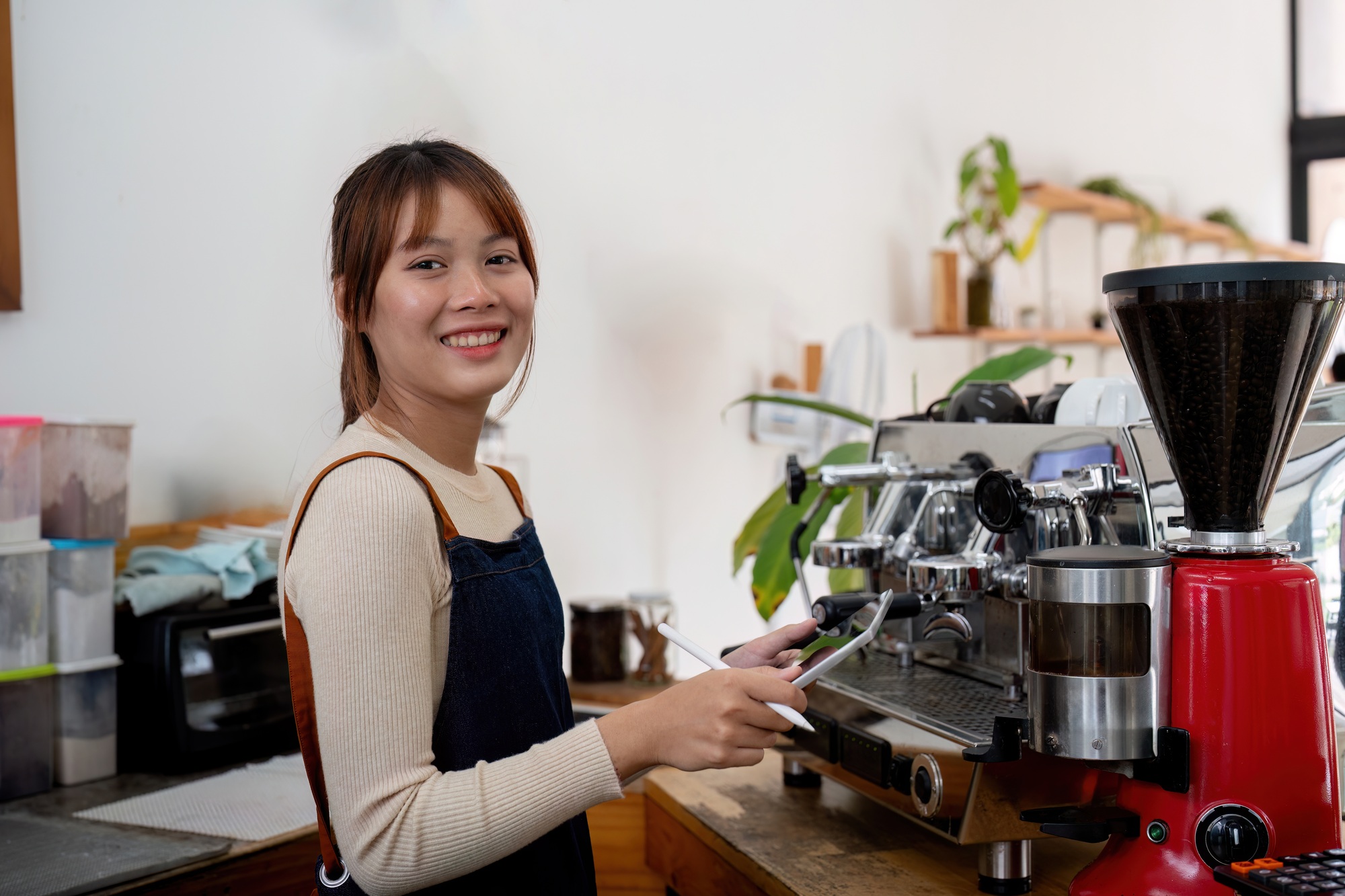 Successful small business owner young asian woman barista stand at her cafe