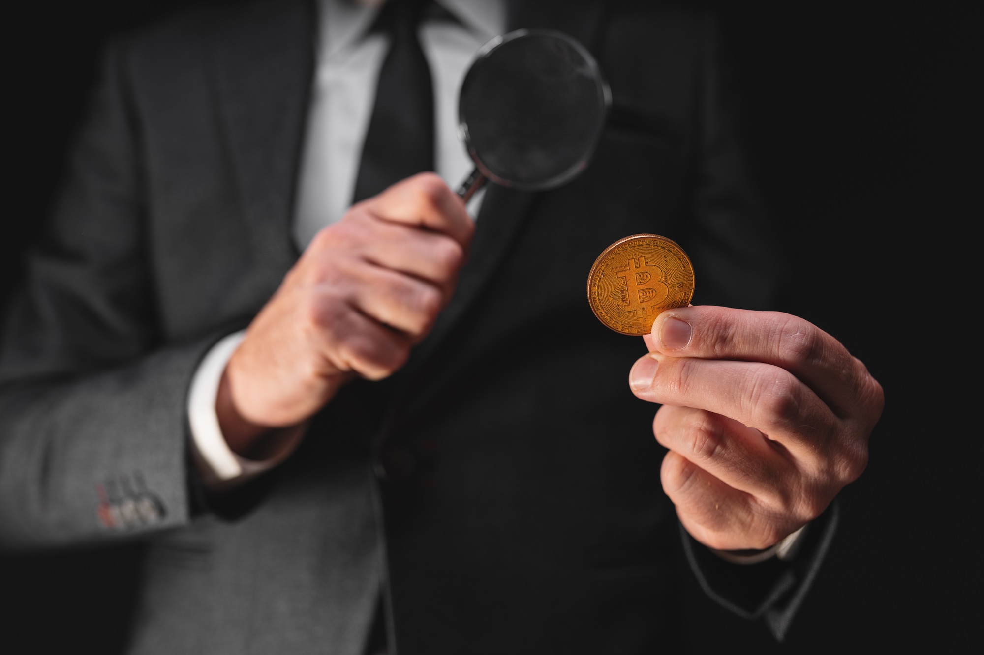 Tax agency officer inspecting Bitcoin cryptocurrency exchange transaction