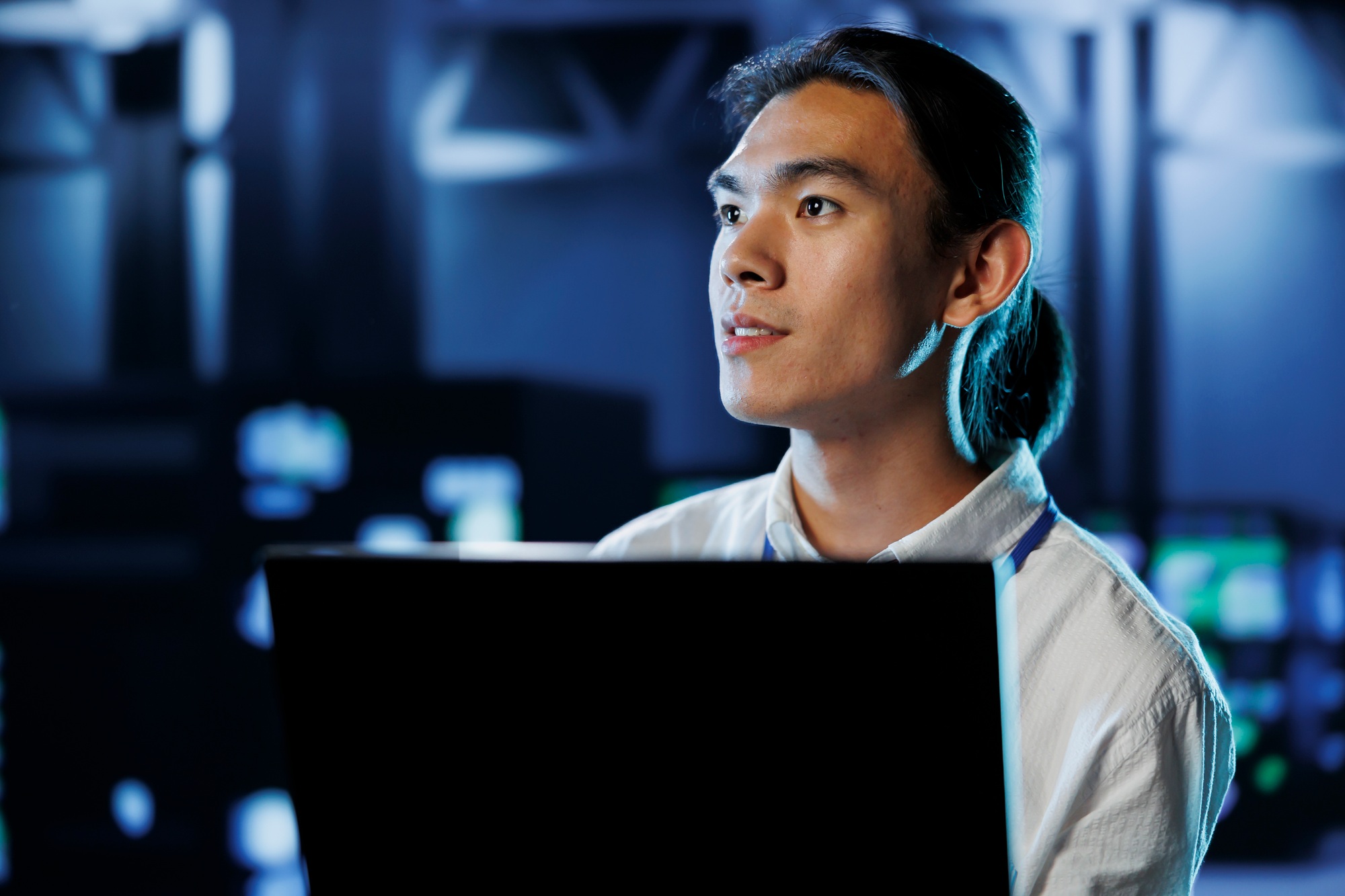 Technician in data center with laptop
