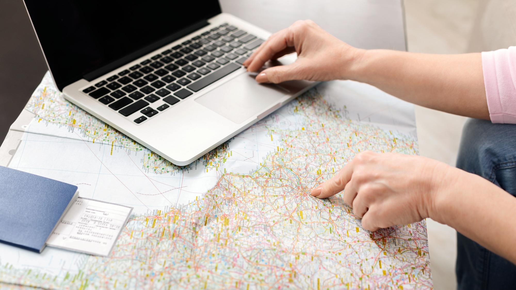 Unrecognizable Woman Using Laptop Computer on Map