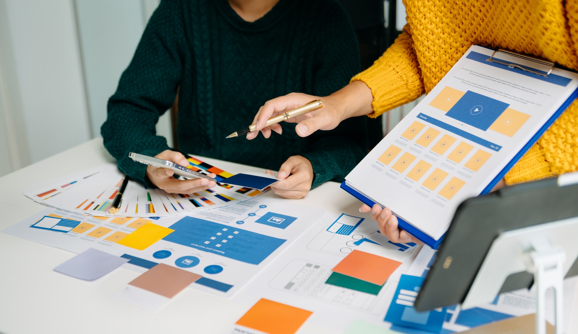UX developer and ui designer brainstorming about mobile app interface wireframe design