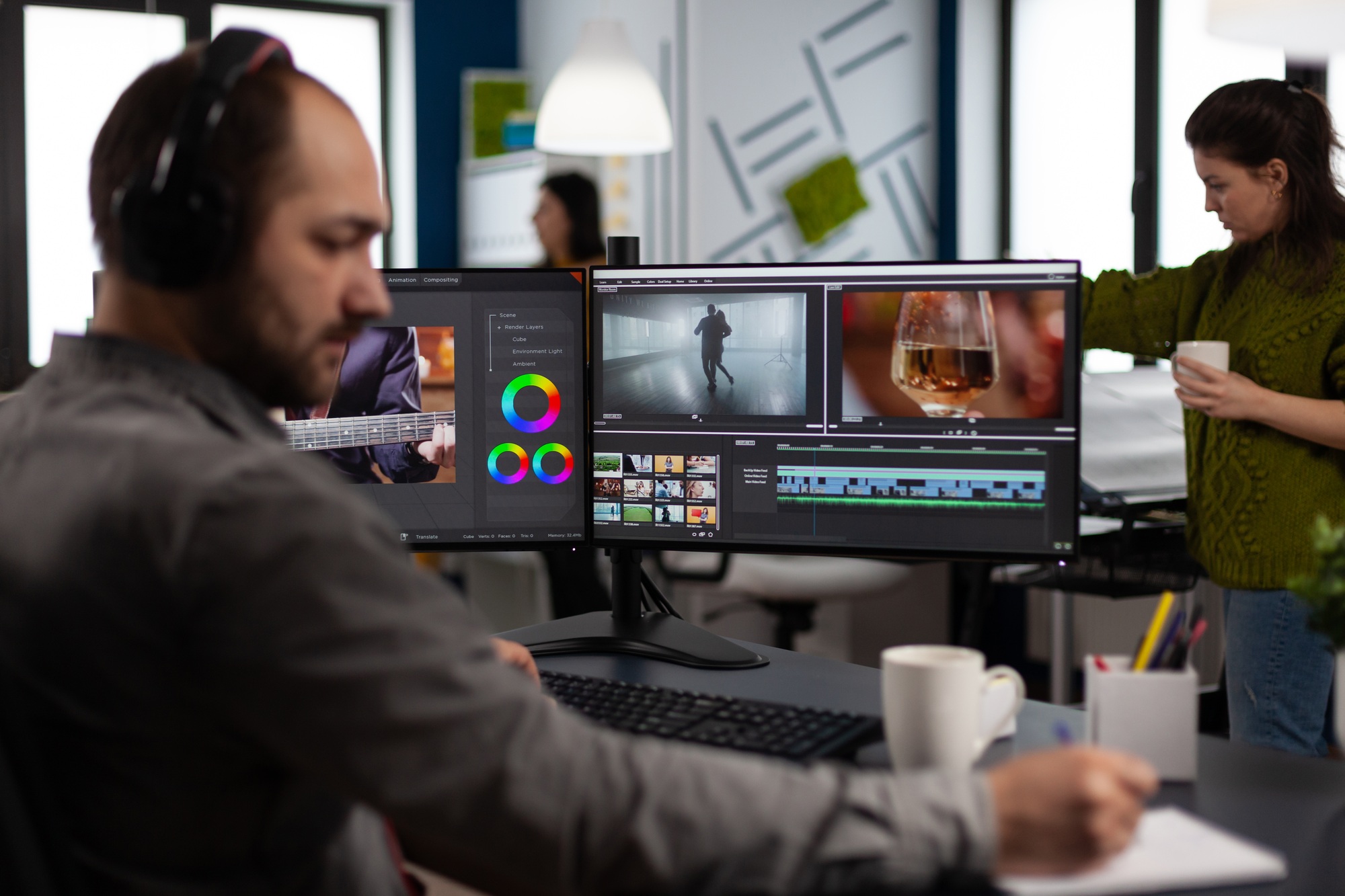 Video maker with headset working with footage and sound on pc with two displays