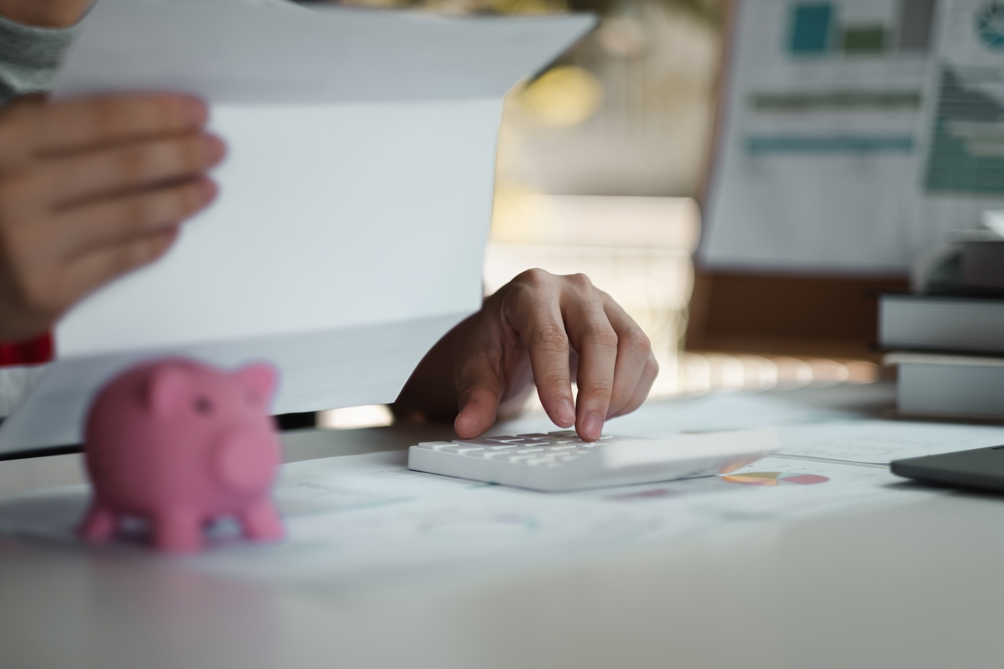 Woman calculating her Debt. woman hand calculating her monthly expenses during tax season with