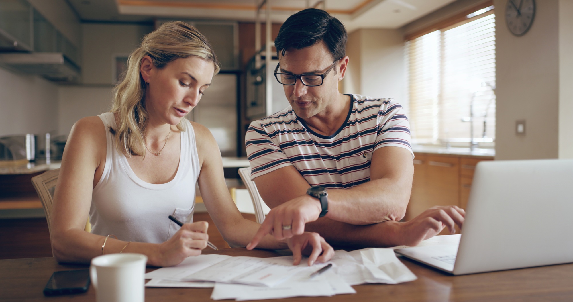 Woman, man and documents in home for finance, laptop and discussion for tax compliance in morning.