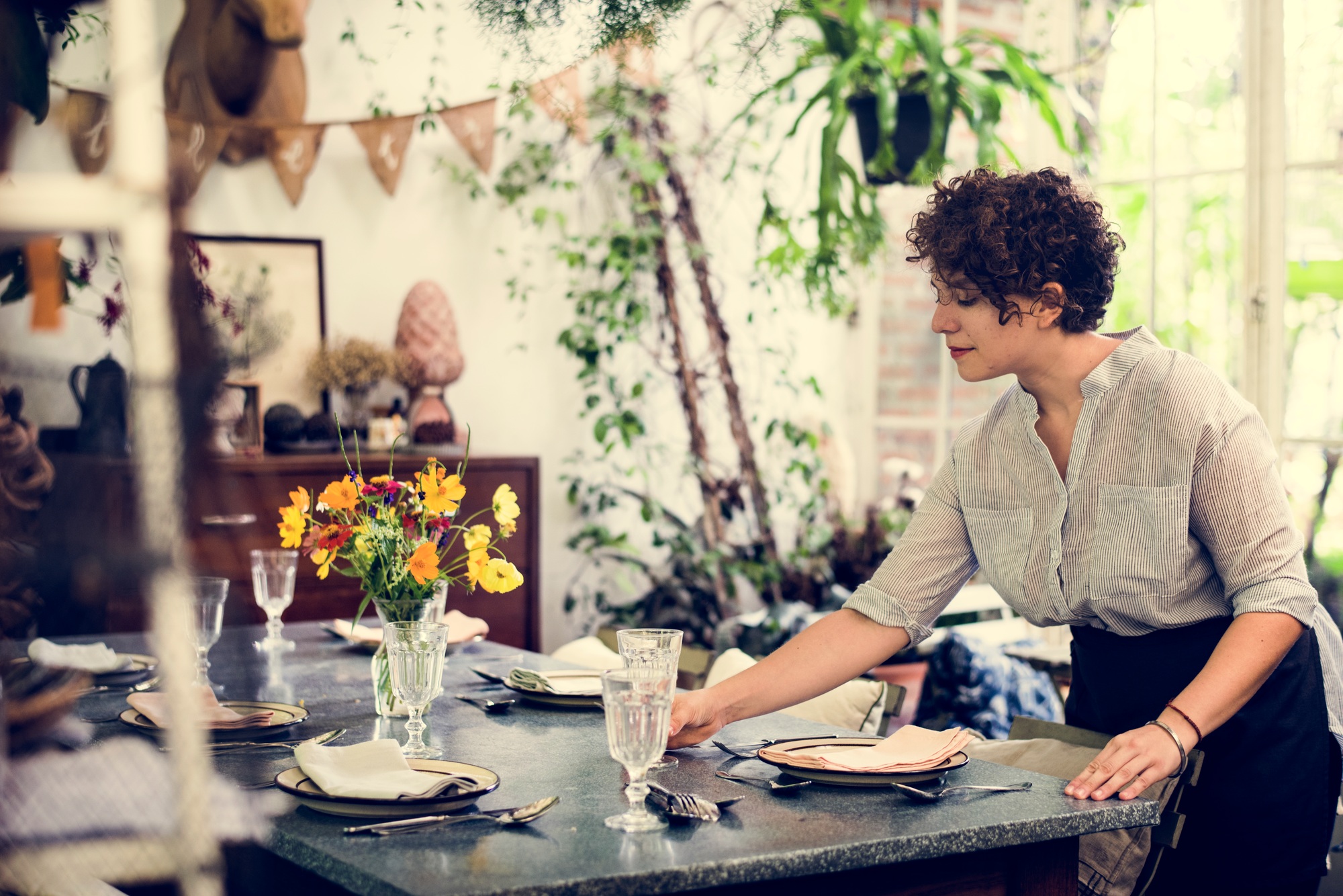Woman setting a table for the customers