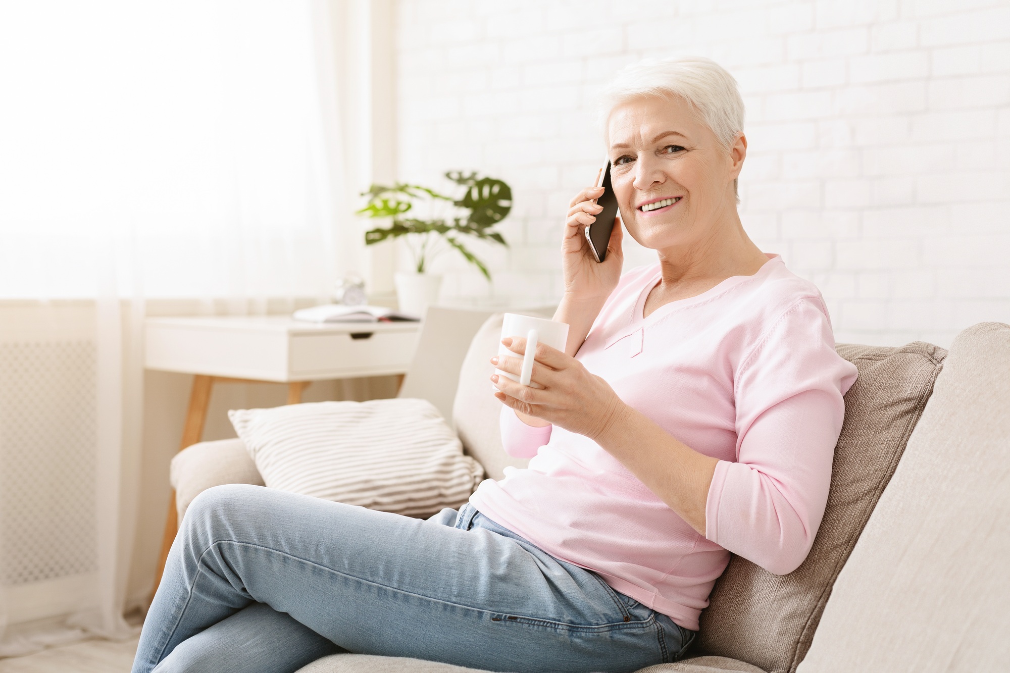 Woman Sitting on Couch Talking on Cell Phone