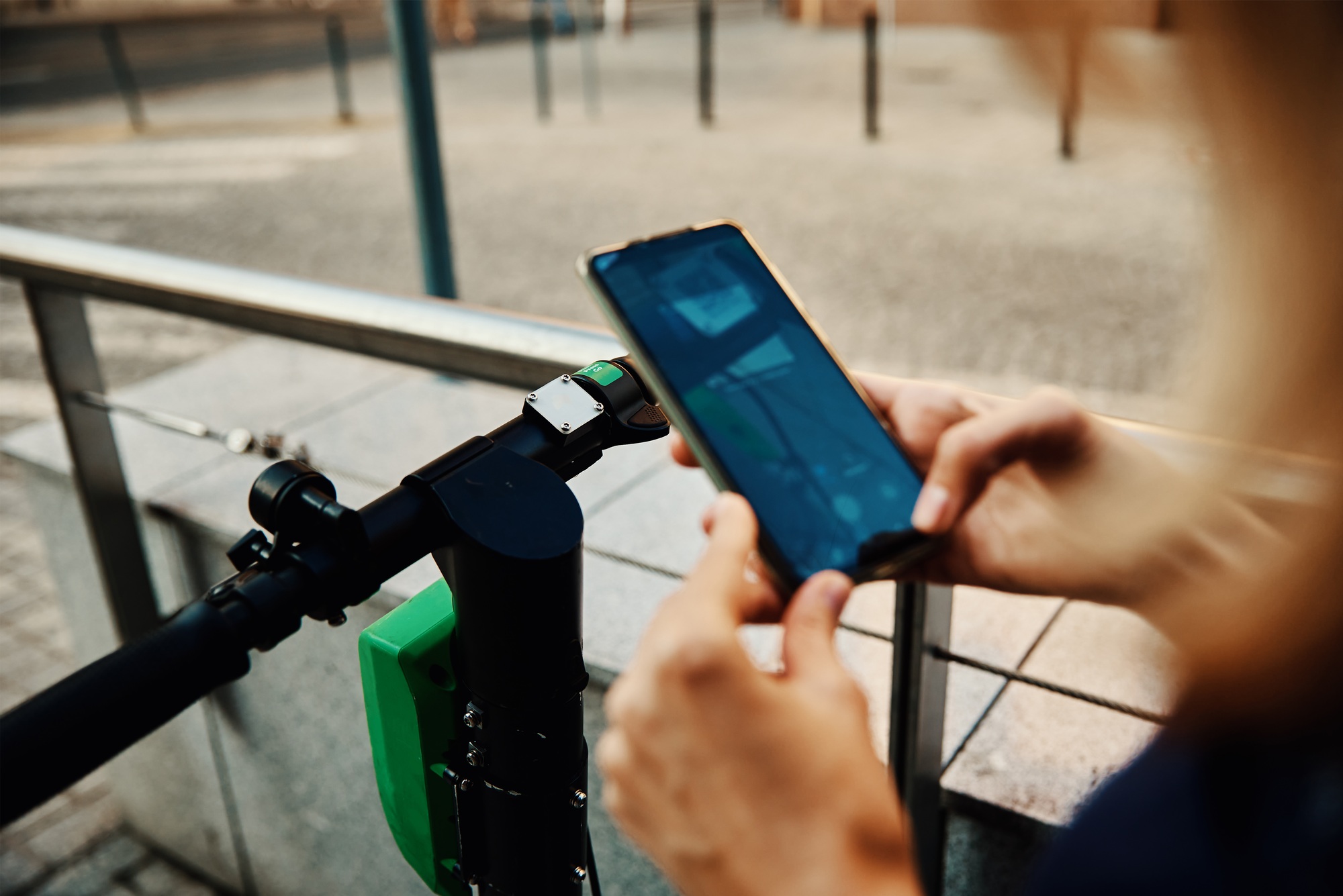 Woman unlock electric scooter for rent with a smartphone application
