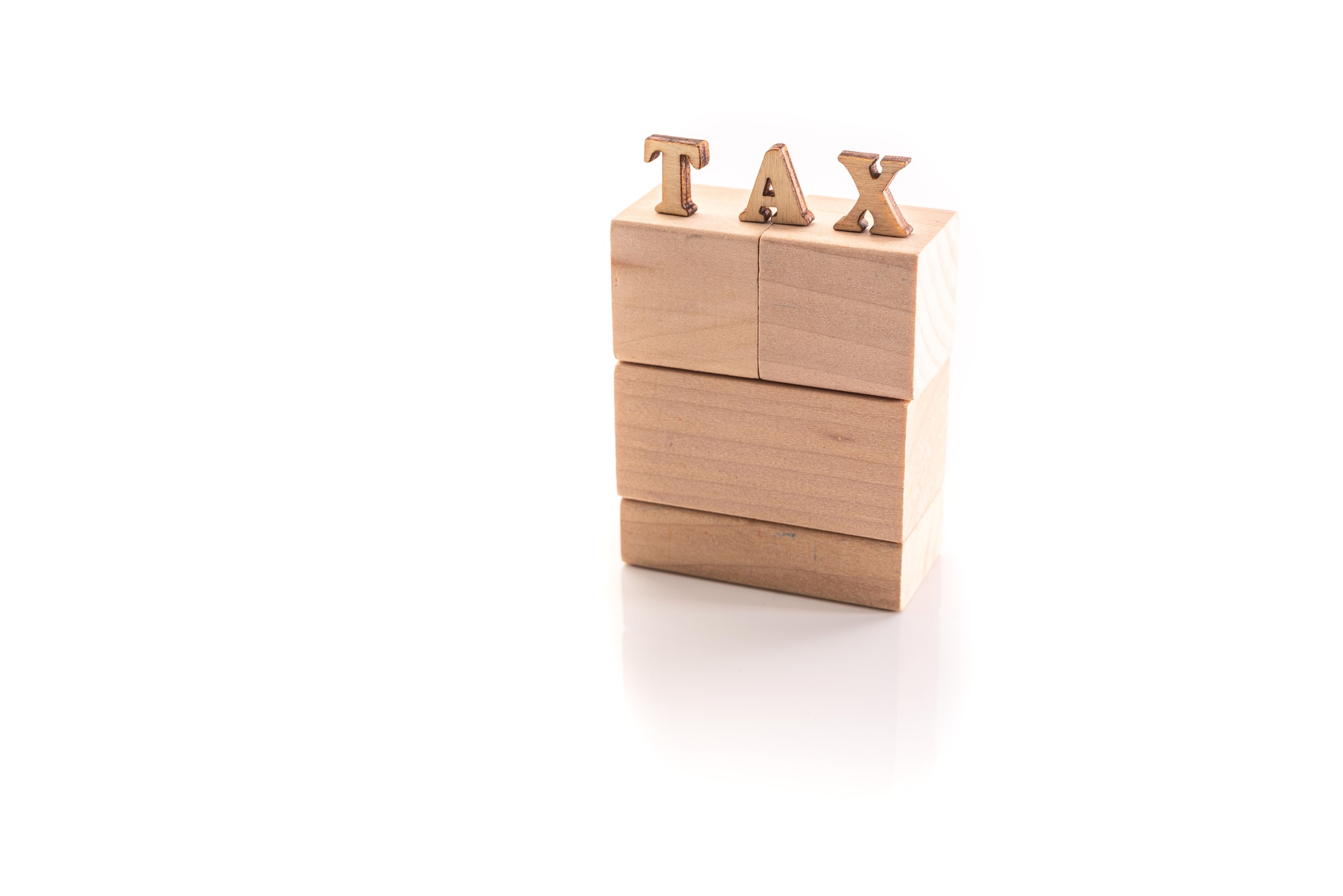 Wooden cubes with the text Tax isolated on white background with copy space.