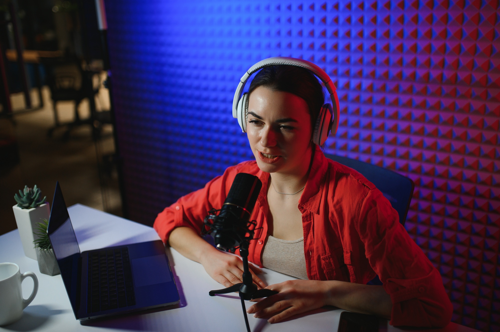 Young attractive woman blogger or vlogger looking at camera and talking on video