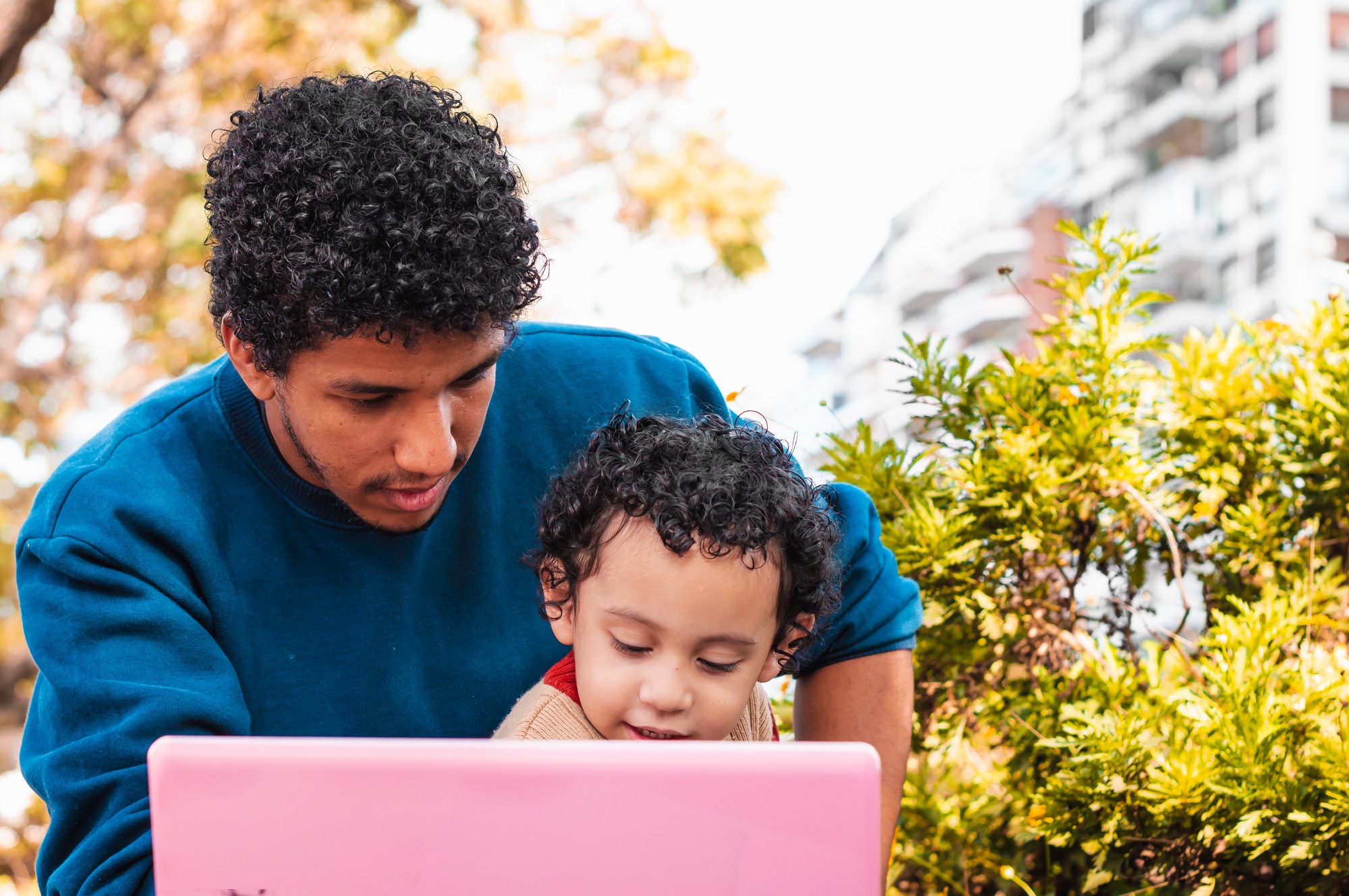 young father on video call with his son