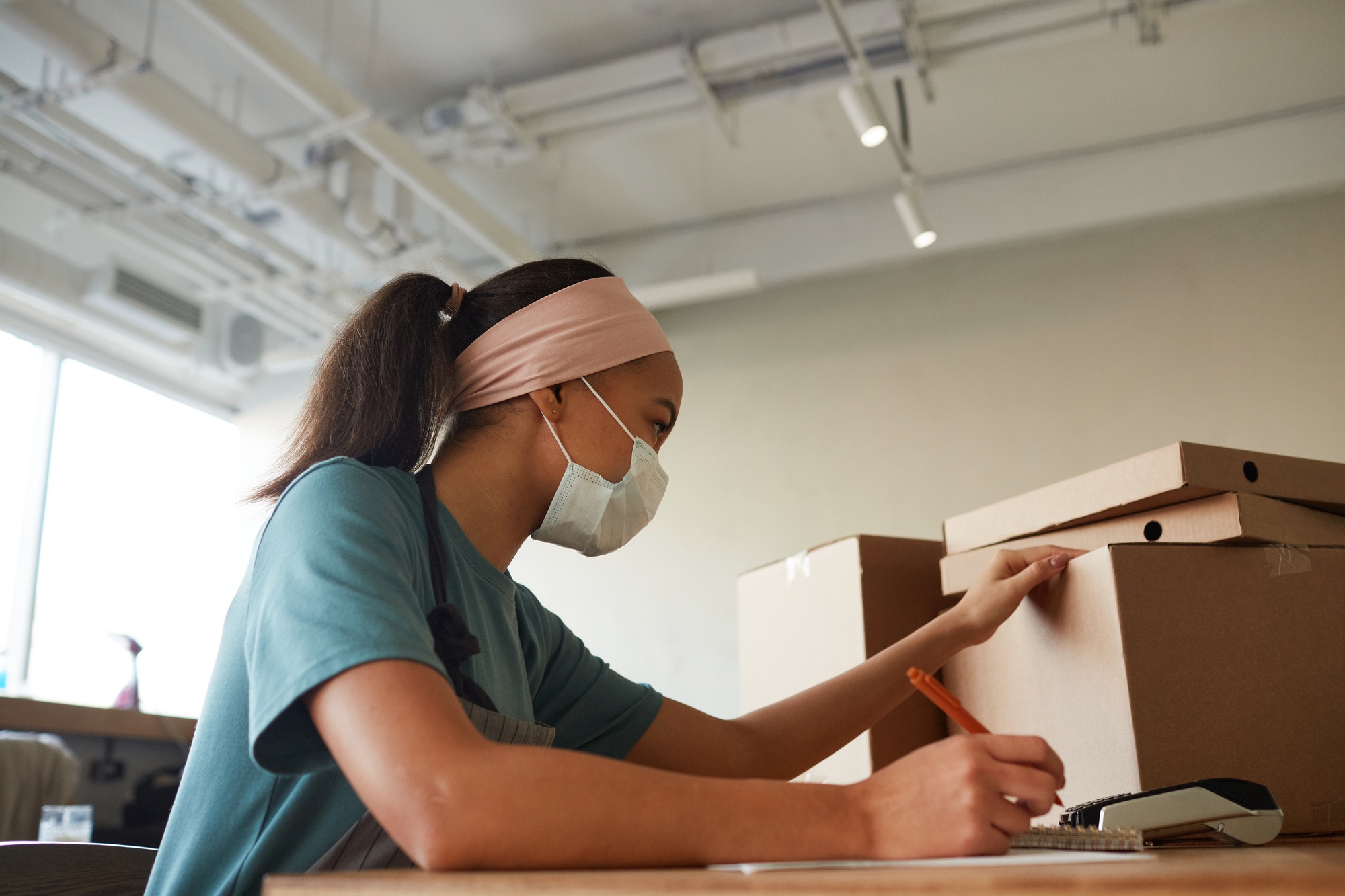 Young Woman Doing Inventory in Shop