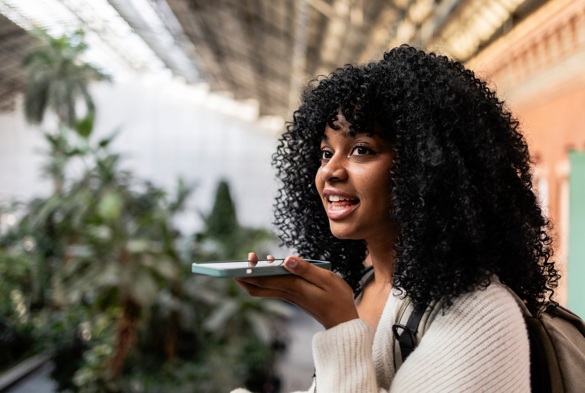 Young woman using voice command on smartphone