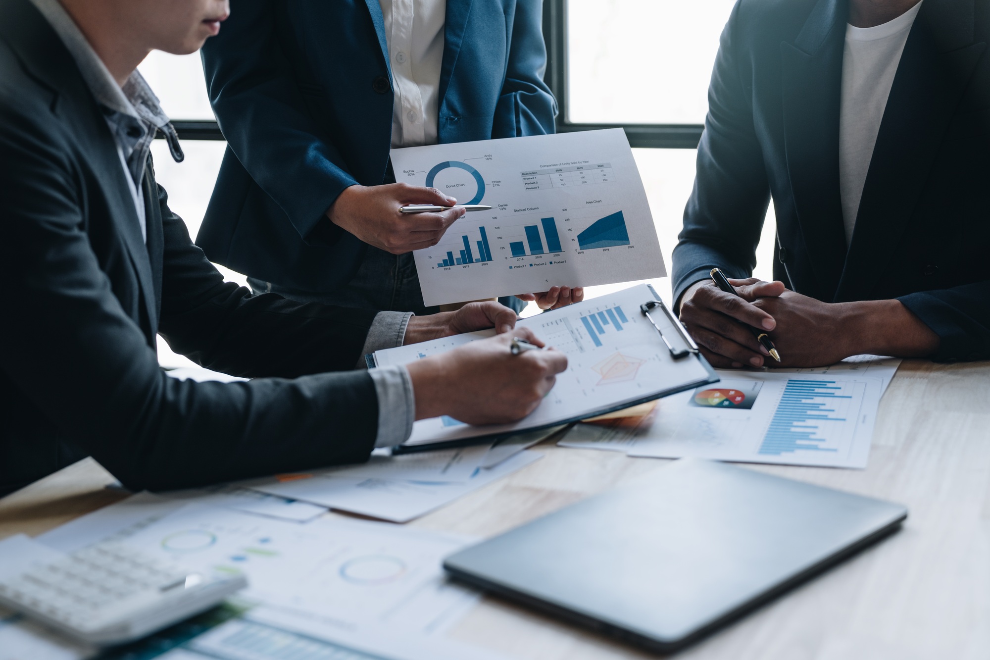A group of Asian businessmen are meeting, planning and discussing data analysis, growth charts, grap