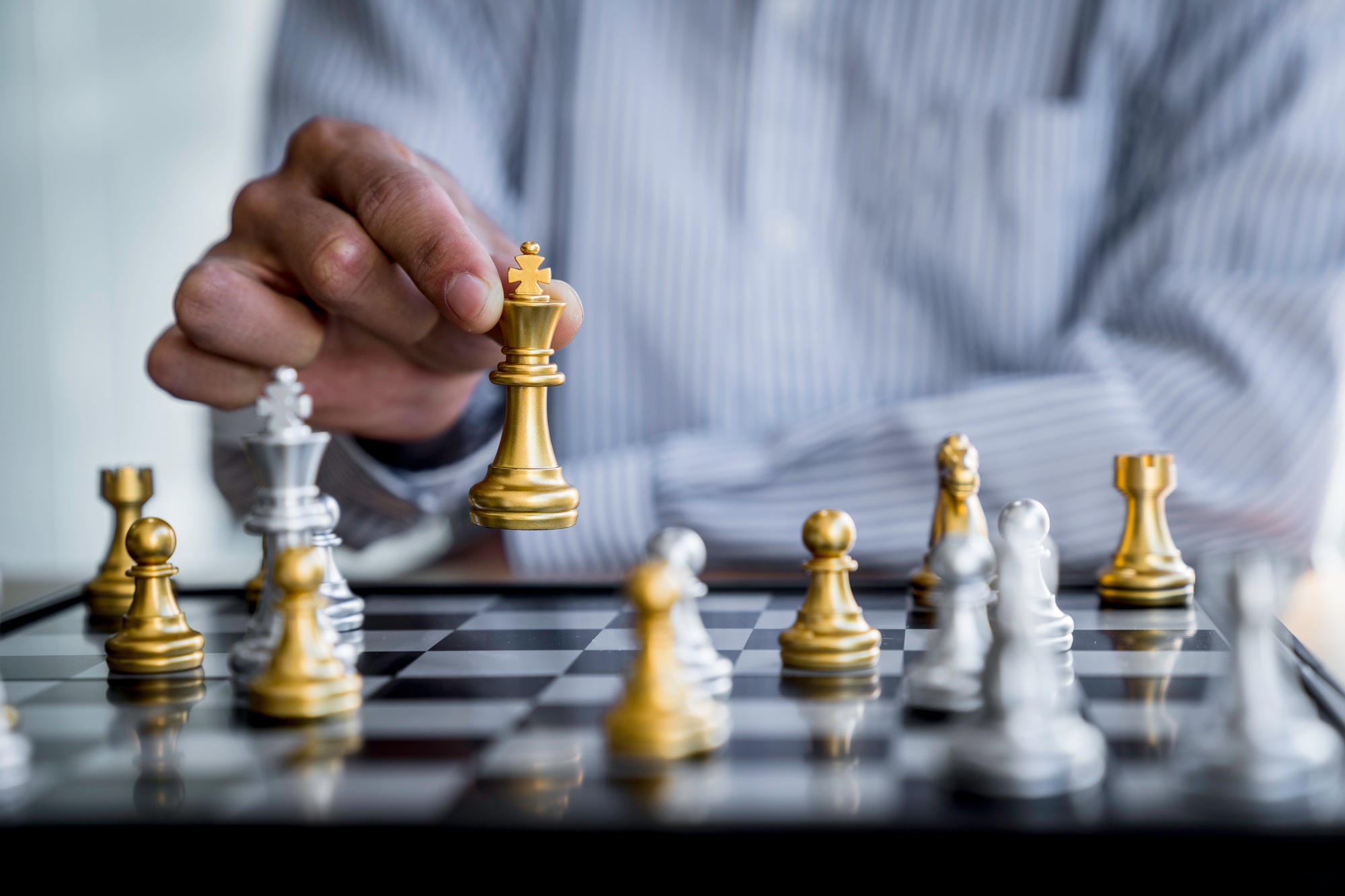 Businessman playing chess game reaching to plan a strategy for success, thinking for planning overco