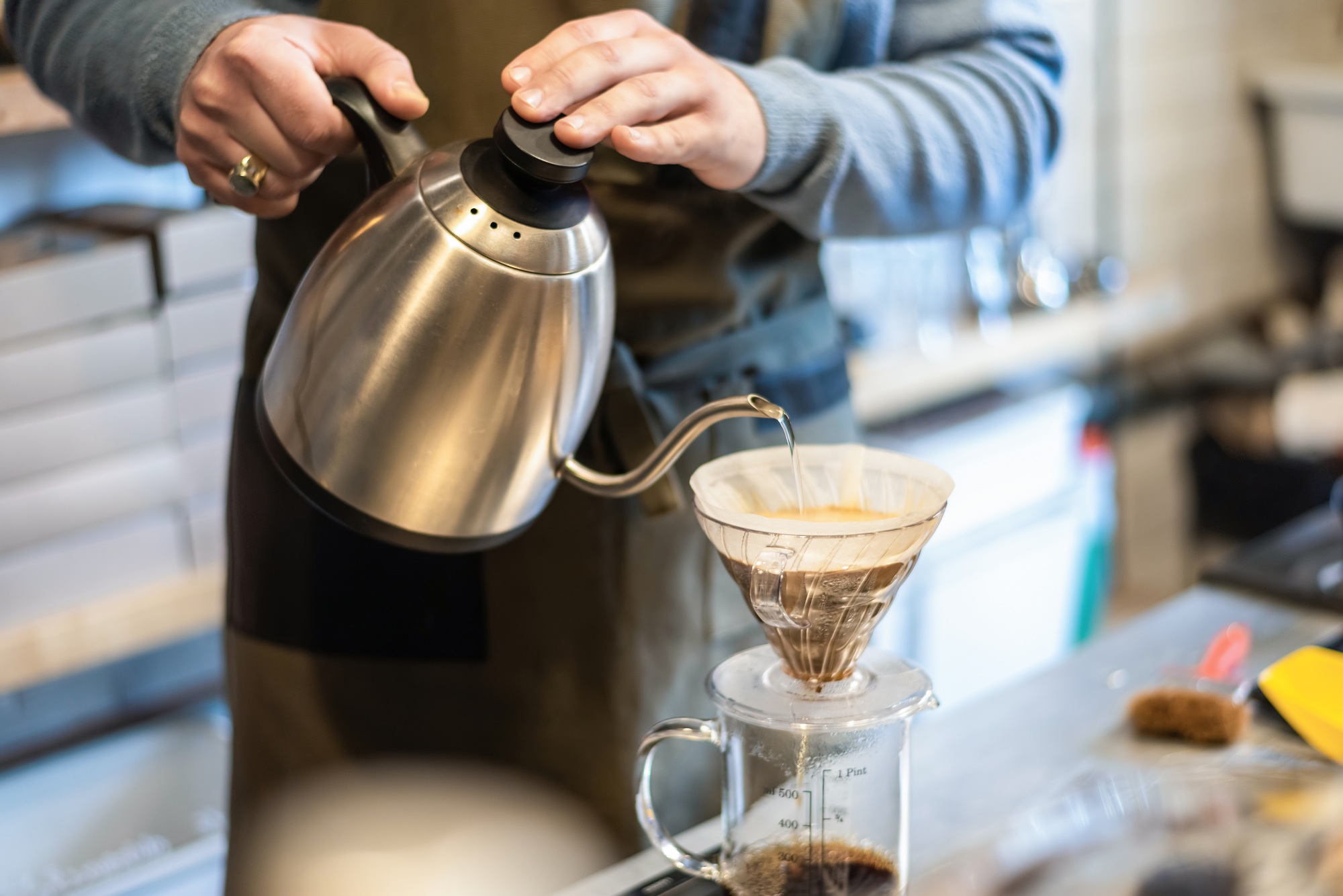 A barista makes coffee in a coffee shop in Brasov, Romania