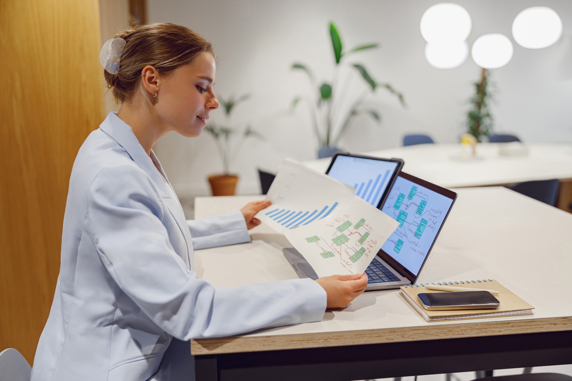 A businesswoman is analyzing key data in a modern office to drive growth and innovation