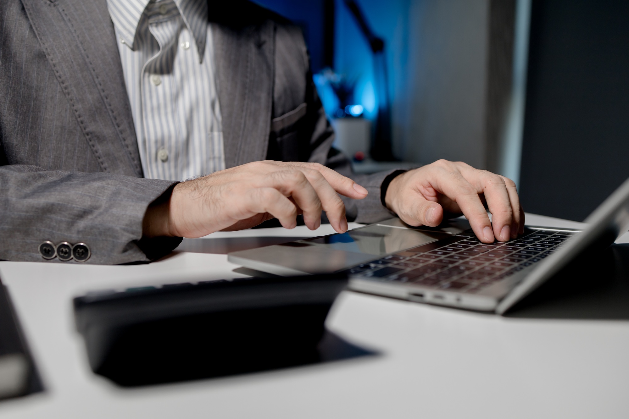 A young businessman is using a laptop to search for important information on business competitors, A
