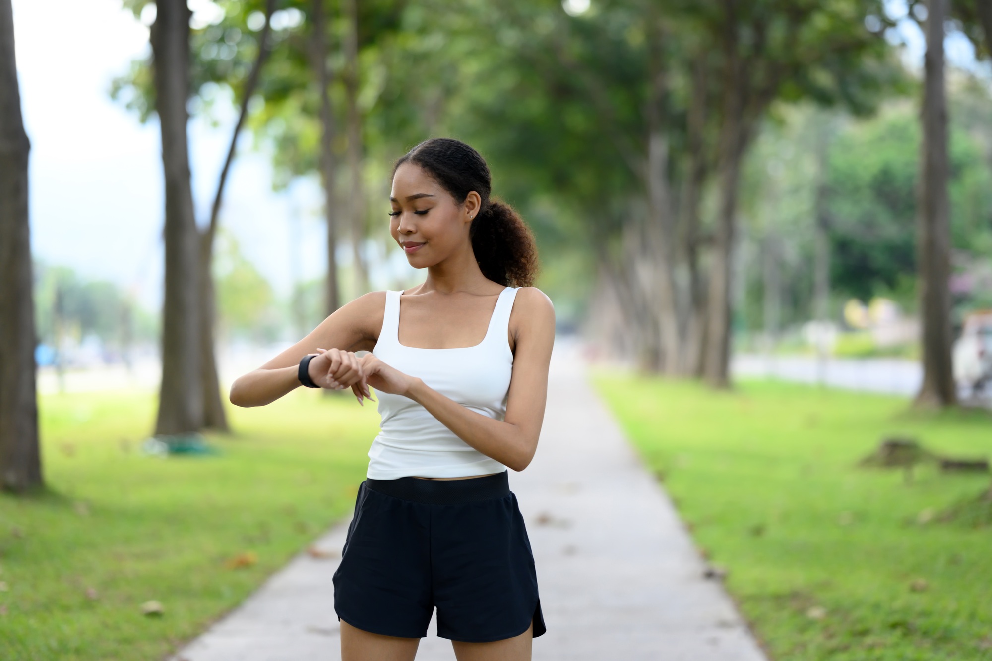 Active young woman monitoring fitness progress on her smartwatch