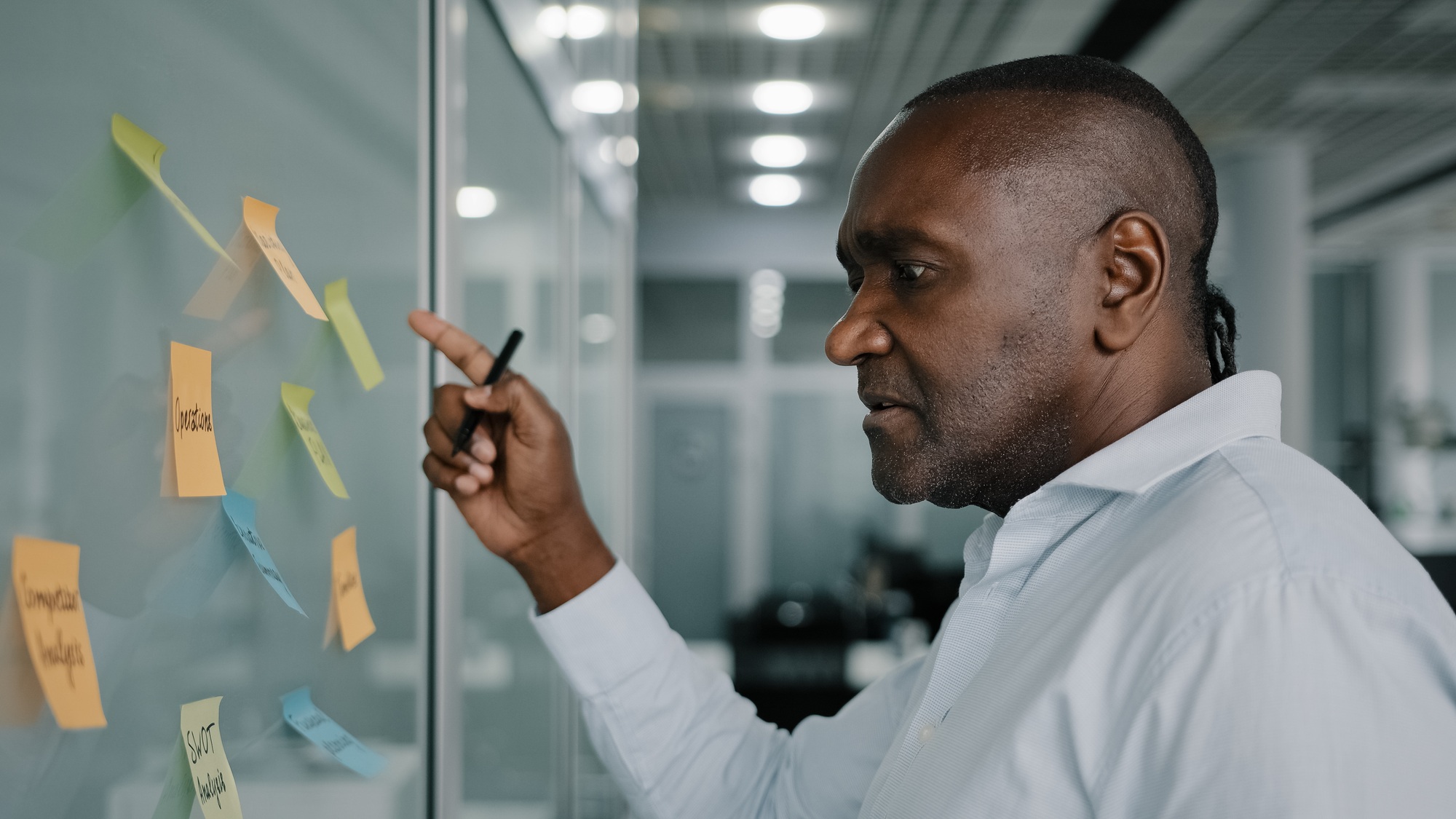 African businessman executive content manager develop strategy plan manage corporate work tasks read