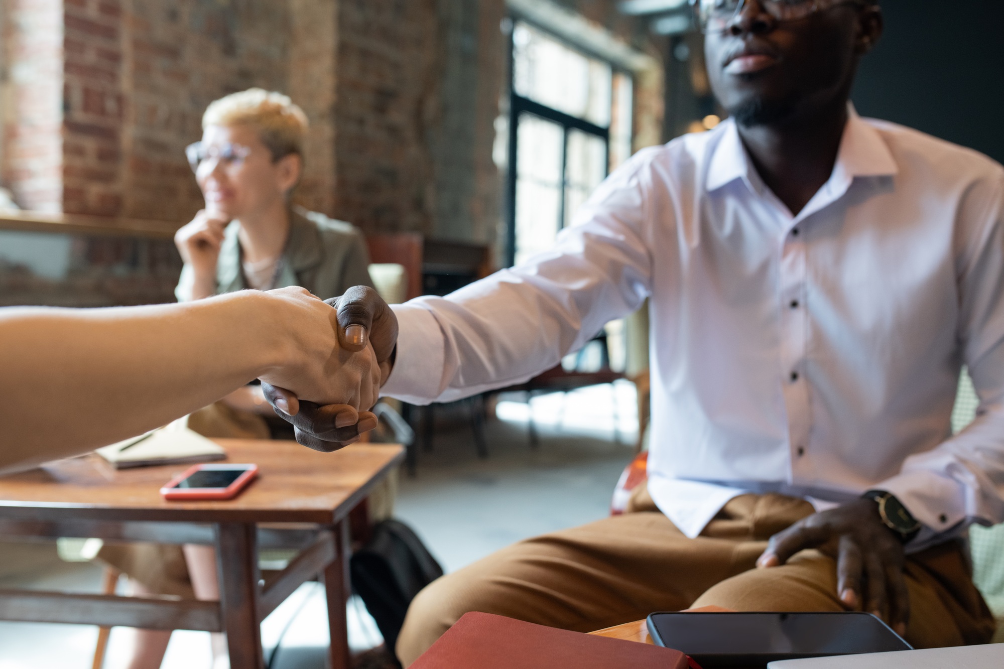 African businessman shaking hand of foreign business partner