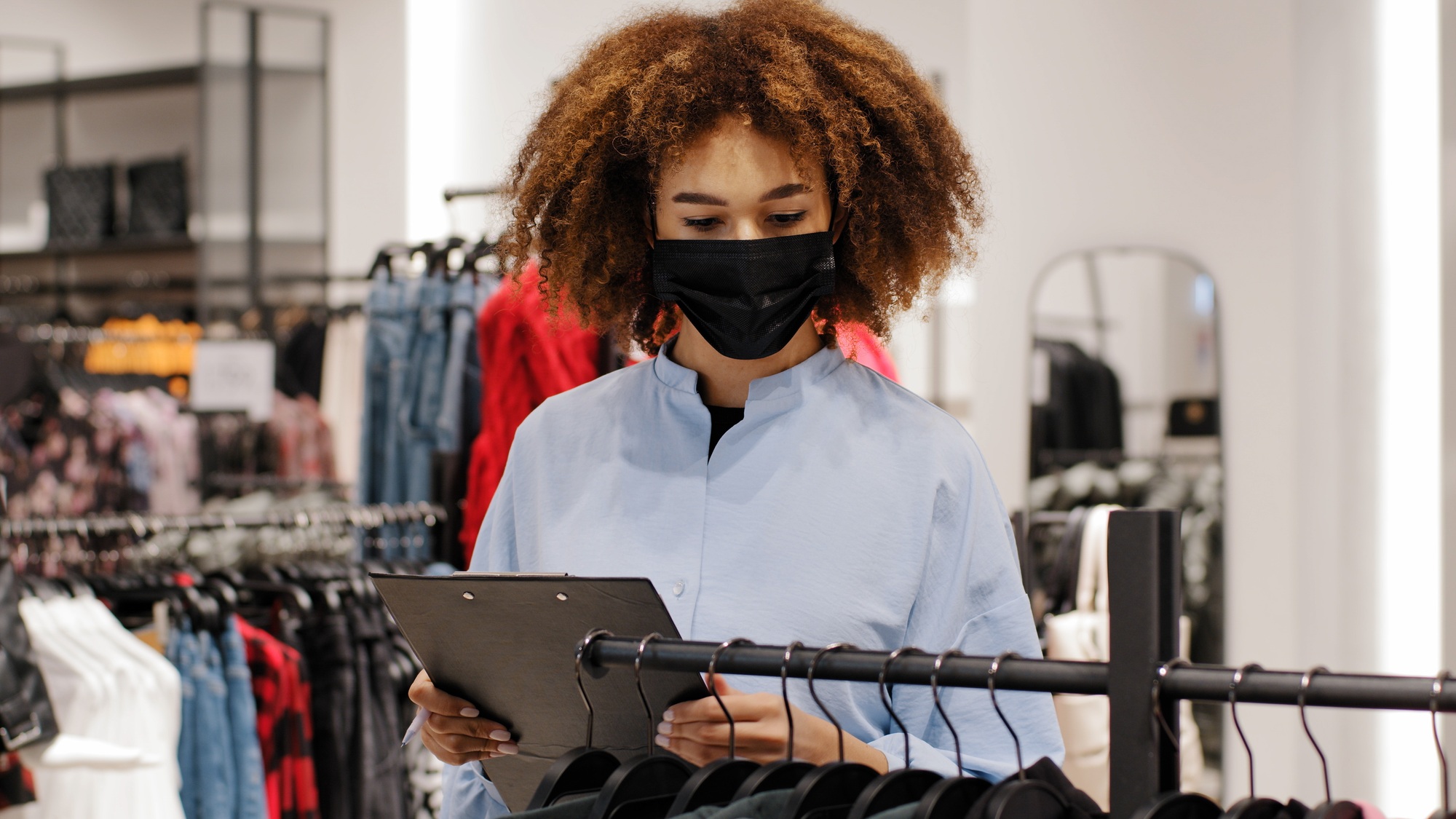 African female shop manager worker girl seller clothing store administrator make inventory