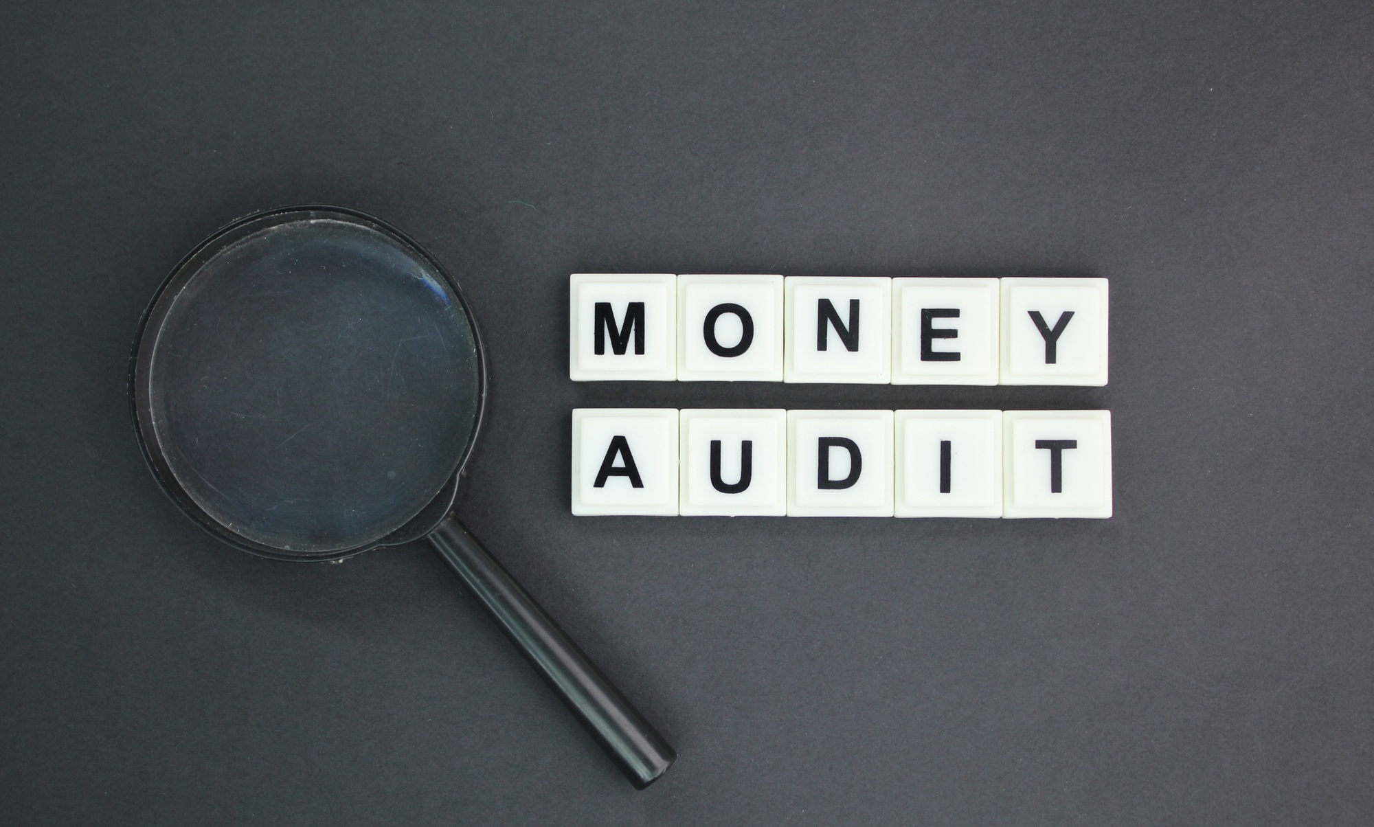 alphabetical letters with money audit words.