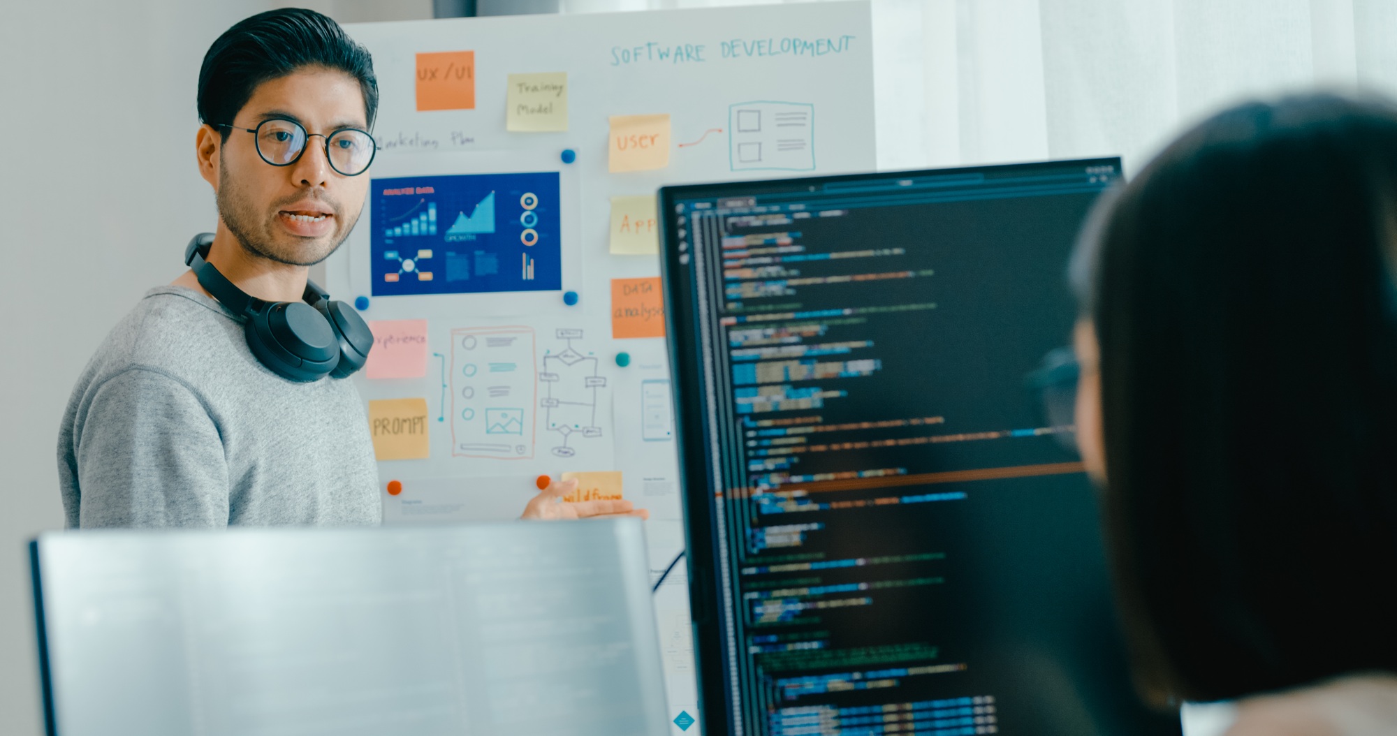 Asia male female software developers mentor leader manager talk strategy plan to executive.